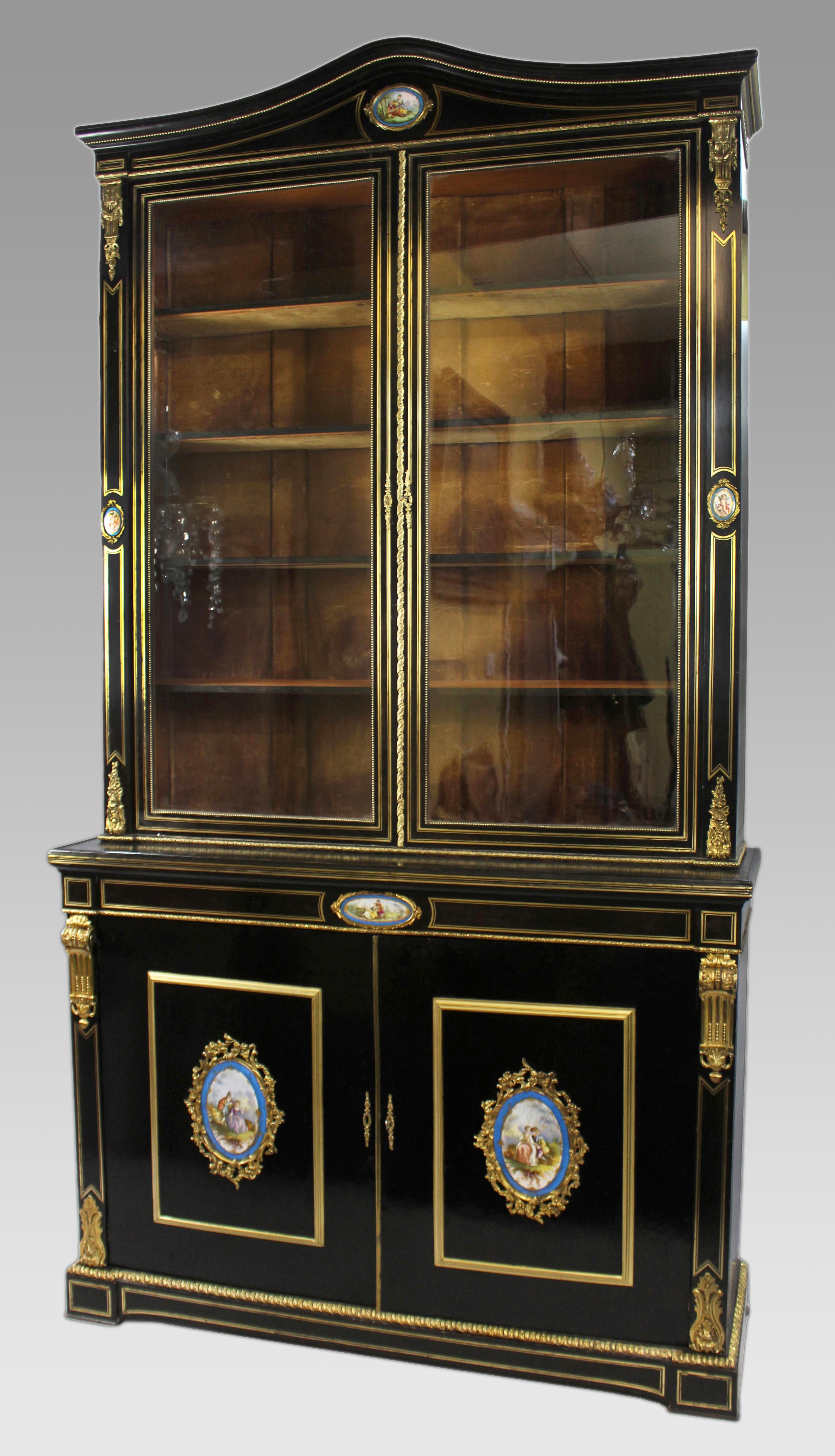 French Ebonized Bookcase with Sevres Plaques, Circa 1820

An elegant early 19th-century French ebonized bookcase, circa 1820. The bookcase features an exceptional combination of craftsmanship, including fine brass inlay and ormolu mounts. The upper