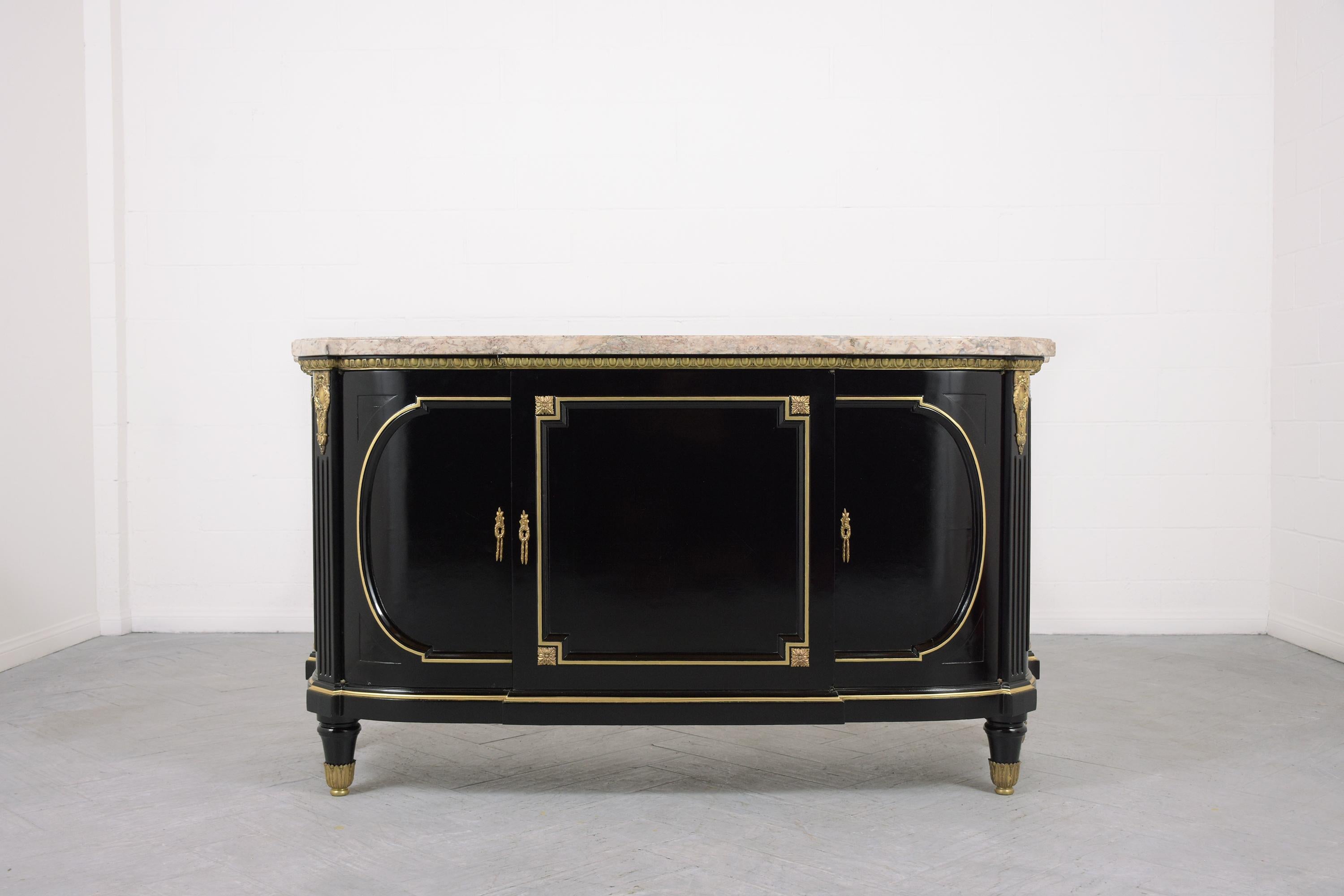 This extraordinary antique french ebonized mahogany Louis XVI buffet is hand-crafted out of mahogany wood, is in great condition, and has been professionally restored by our team of craftsmen in the house. This fabulous credenza features it's