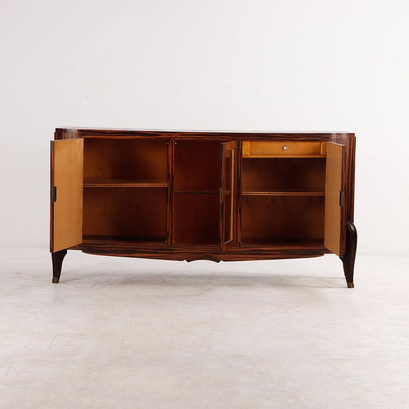 This striking French Art Deco sideboard is masterfully crafted from rich Macassar ebony, showcasing bold grain and timeless elegance. Its two lockable doors open to reveal fully adjustable shelves, combining refined sophistication with everyday