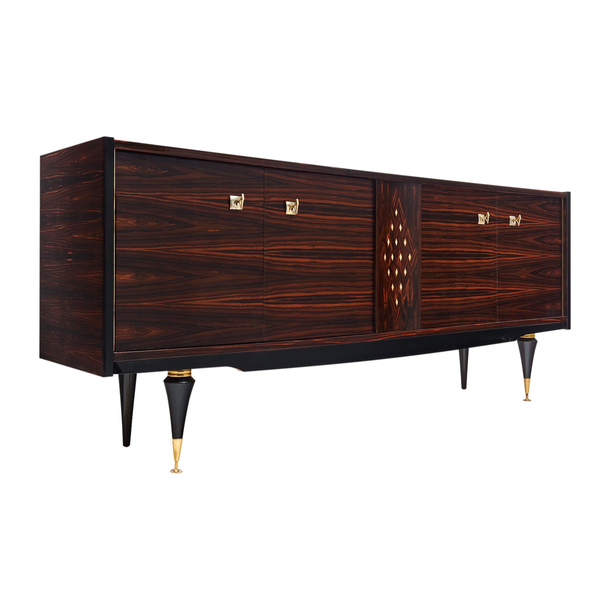 Buffet from France made of rare Macassar of ebony wood with a beautiful grain pattern throughout. The center panel features a parquetry design with lemon wood inlay in a diamond pattern. The case piece has four doors that open to interior lemon wood