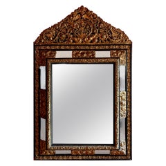 Miroir français en laiton repoussé et ébène avec verre biseauté