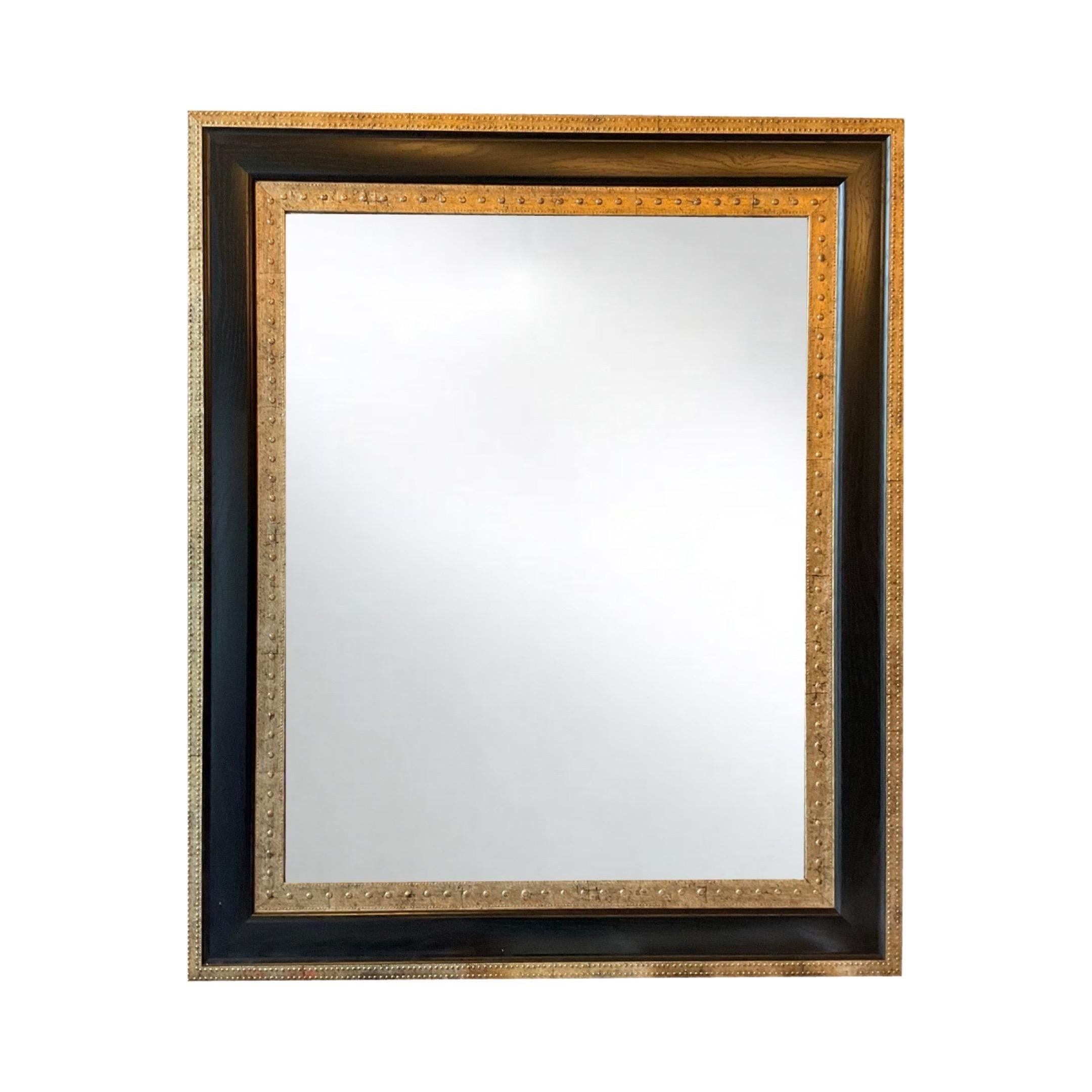 Crafted in the 1940s, this French Ebony Wood Mirror exudes elegance and sophistication. Made of rich ebony wood with a stunning gold leaf finish, it adds a touch of luxury to any space. Enjoy the timeless beauty and quality craftsmanship of this