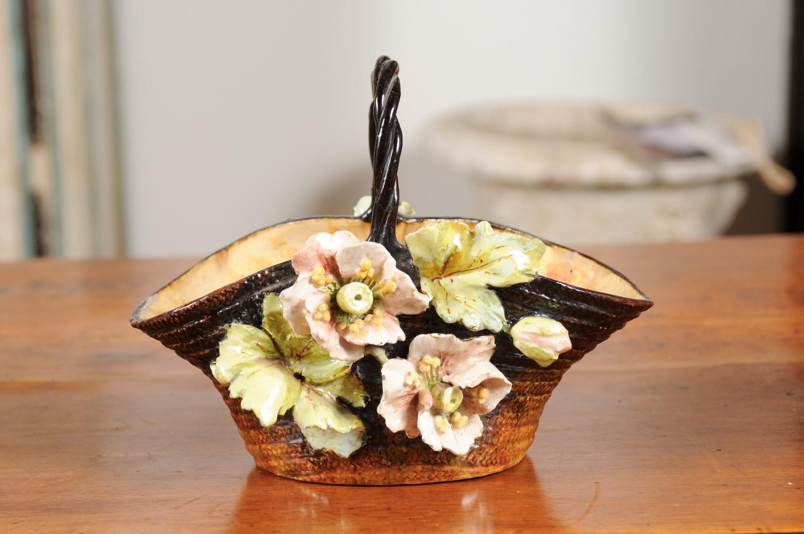 A French 19th century jardinière basket from the School of Fontainebleau with high relief floral barbotine décor. Born in France during the 19th century, this exquisite jardinière features a brown and russet textured ground imitating a wicker