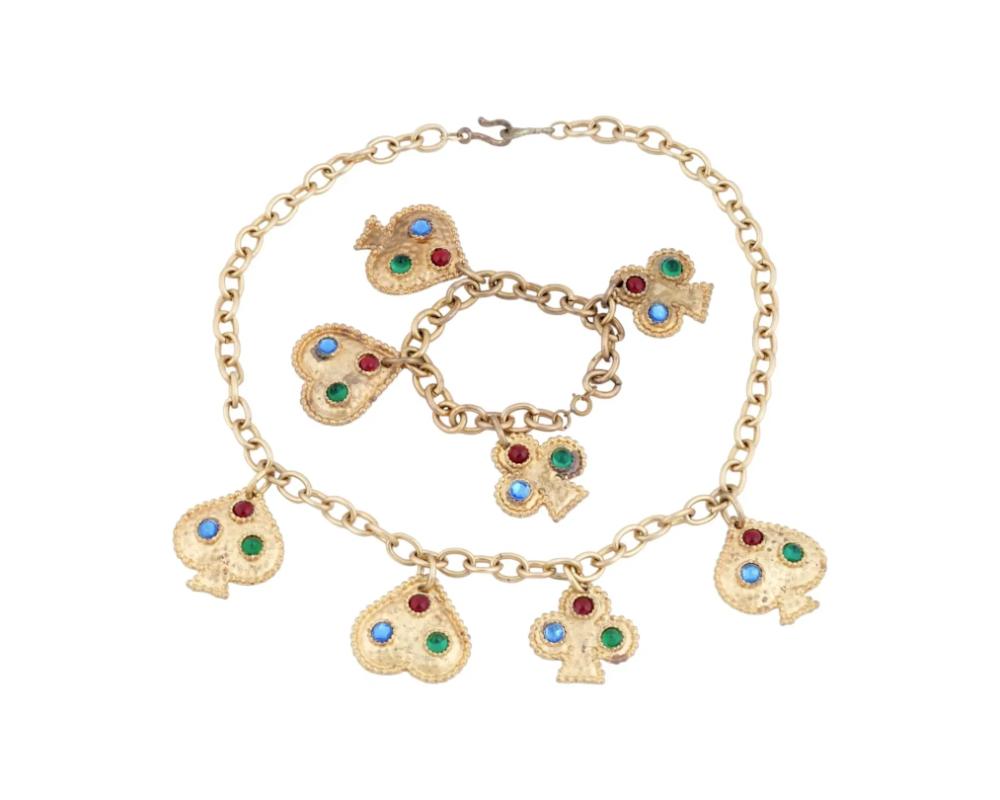 A vintage French Edouard Rambaud hammered brushed gold tone card suits design set of a necklace and a bracelet. The necklace and the bracelet are made in a chain link design and adorned with figural heart, spade and clubs shaped charms, encrusted