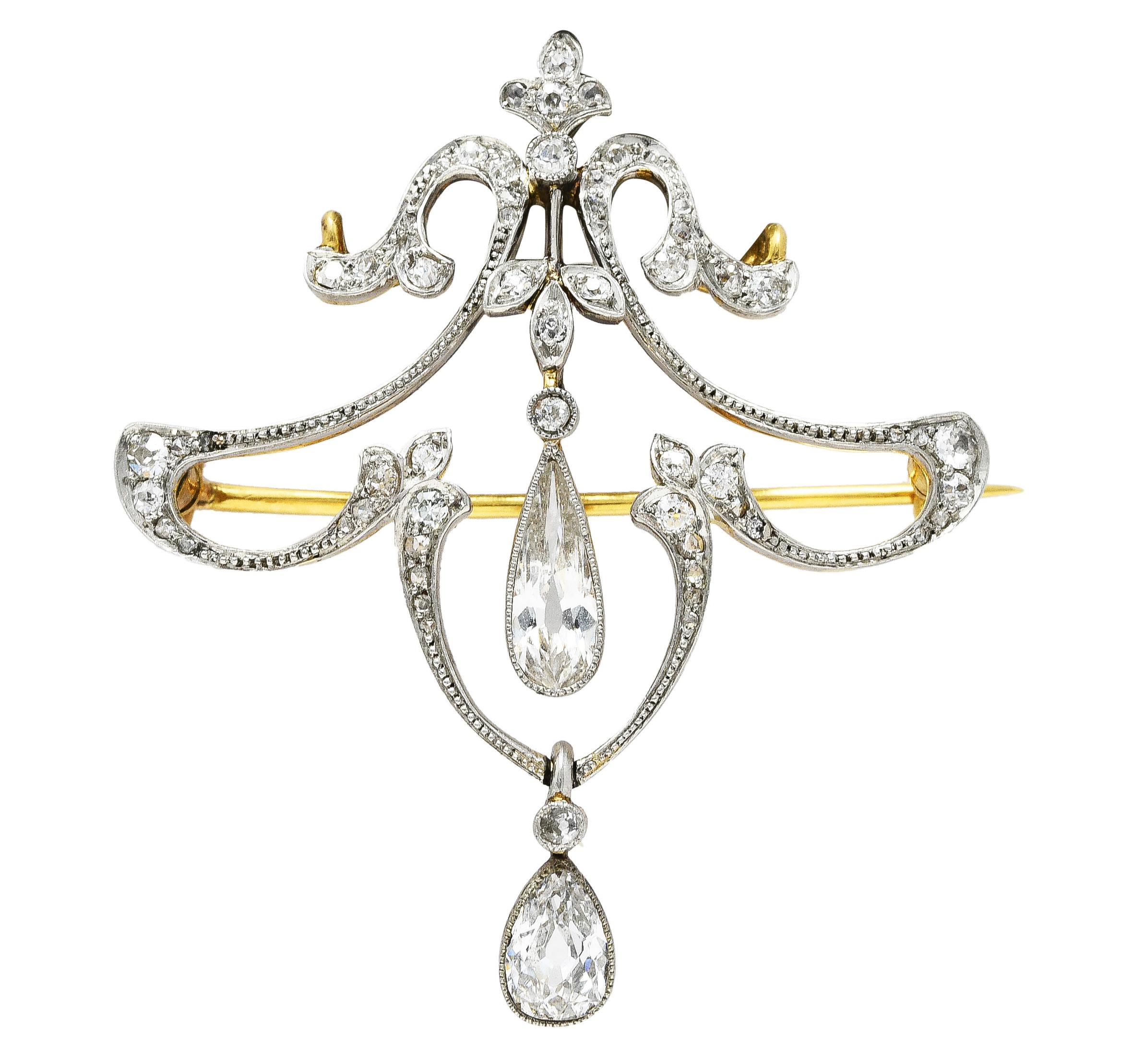 Necklace centers a fluted platinum-topped gold pendant with foliate and fleur-de-lis motifs. Featuring old European, single, and rose cut diamonds bead and flush set throughout. Weighing approximately 0.60 carat total - quality consistent with age.