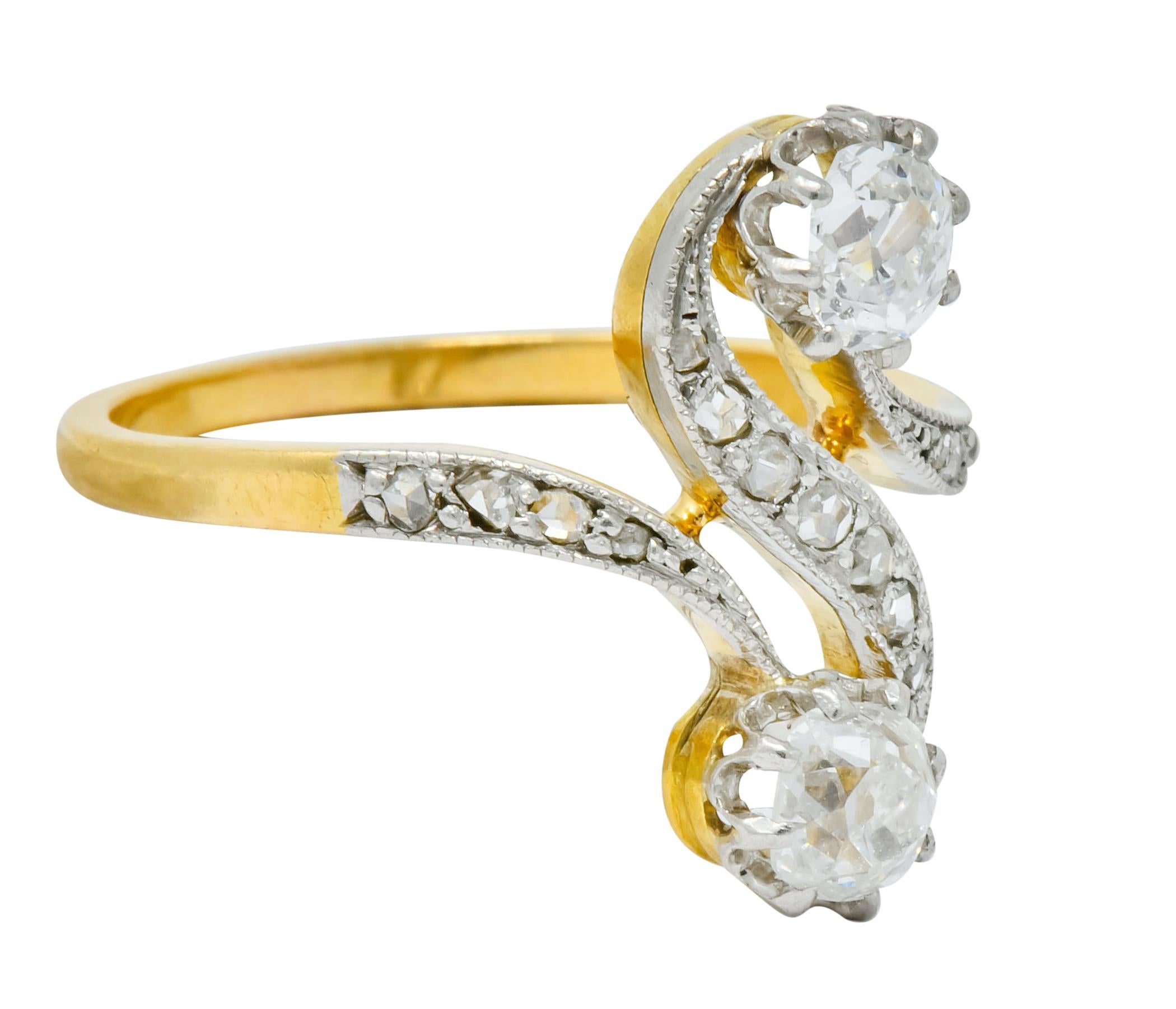 Bypass style ring centers two old mine cut diamonds - claw set opposed in an 'S' motif

Double diamond motif is the Toi et Moi style to mean 'You and Me'

Old mine cut diamonds weigh in total approximately 0.54 carat - H/I color with SI
