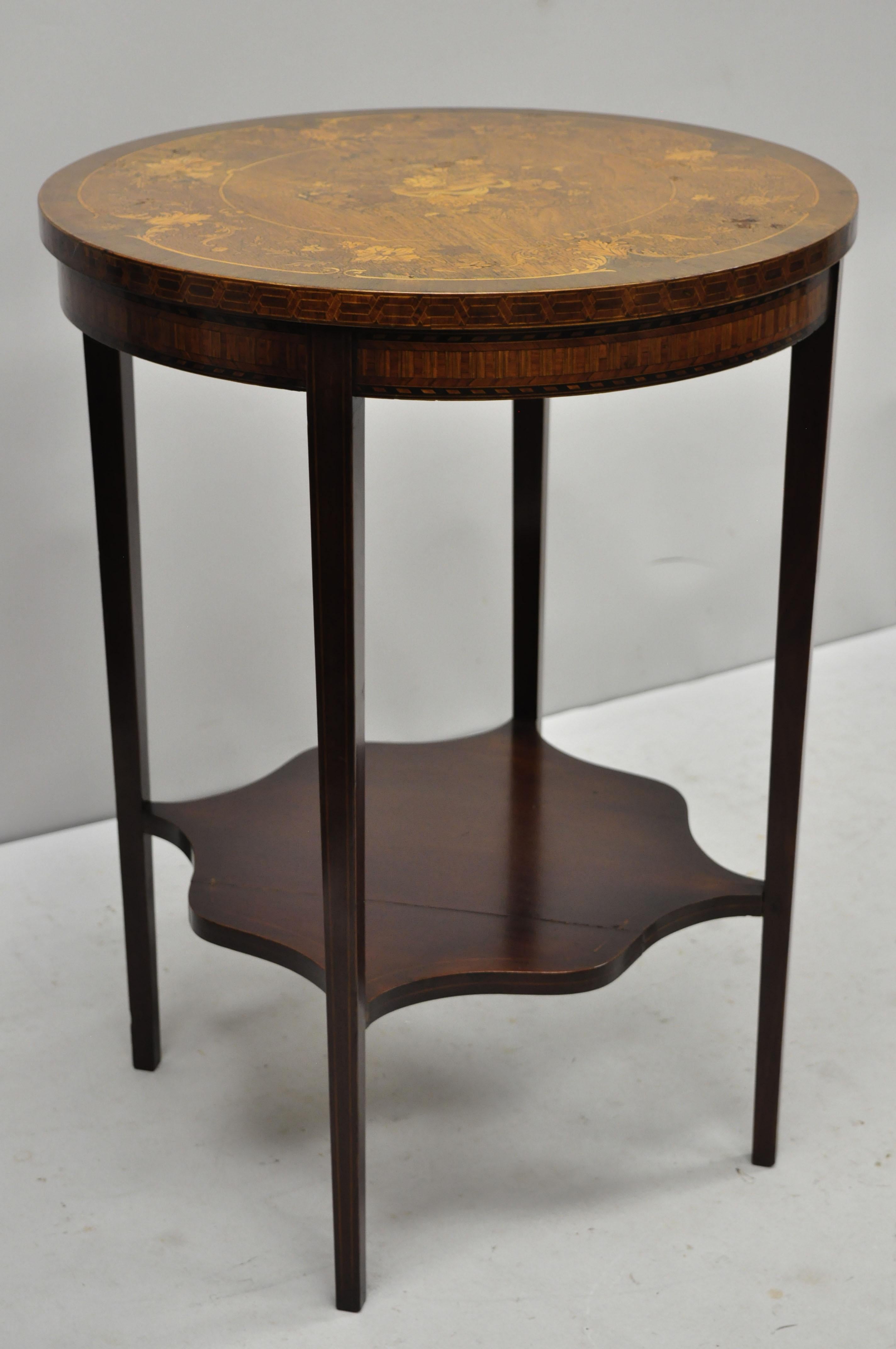 French Edwardian floral marquetry satinwood inlay round accent side table. Item features marquetry inlaid skirt, floral inlaid top, lower shelf, tapered legs, very nice antique item, great style and form, circa early 20th century. Measurements: 28