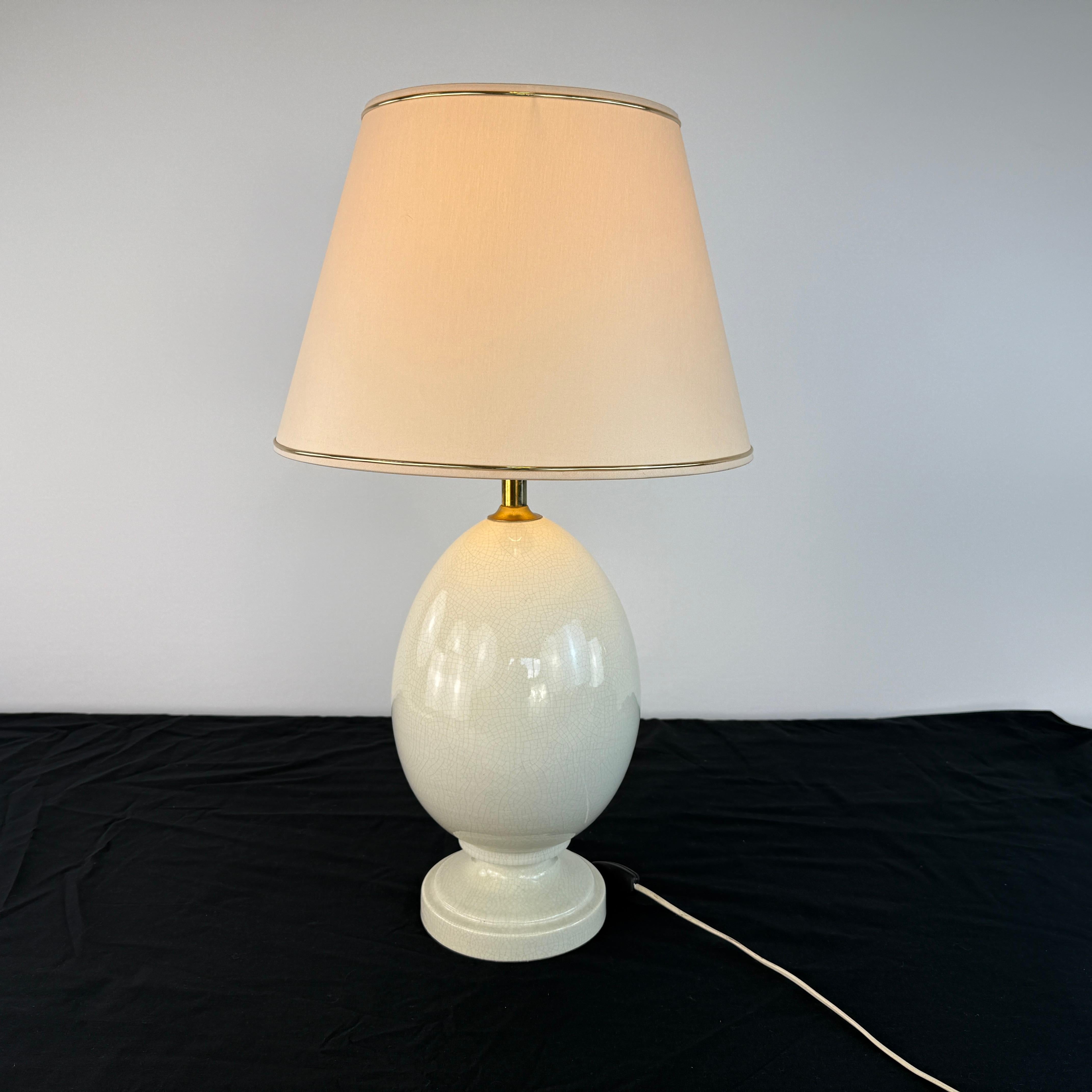 Dimensions: H 22” x W 10.3”

Vintage French crackle-glazed ceramic egg table lamp with fabric lampshade. A wonderful addition to your interior.
Please see our other listings for ideas and matching pieces.

Condition: Condition consistent with age.