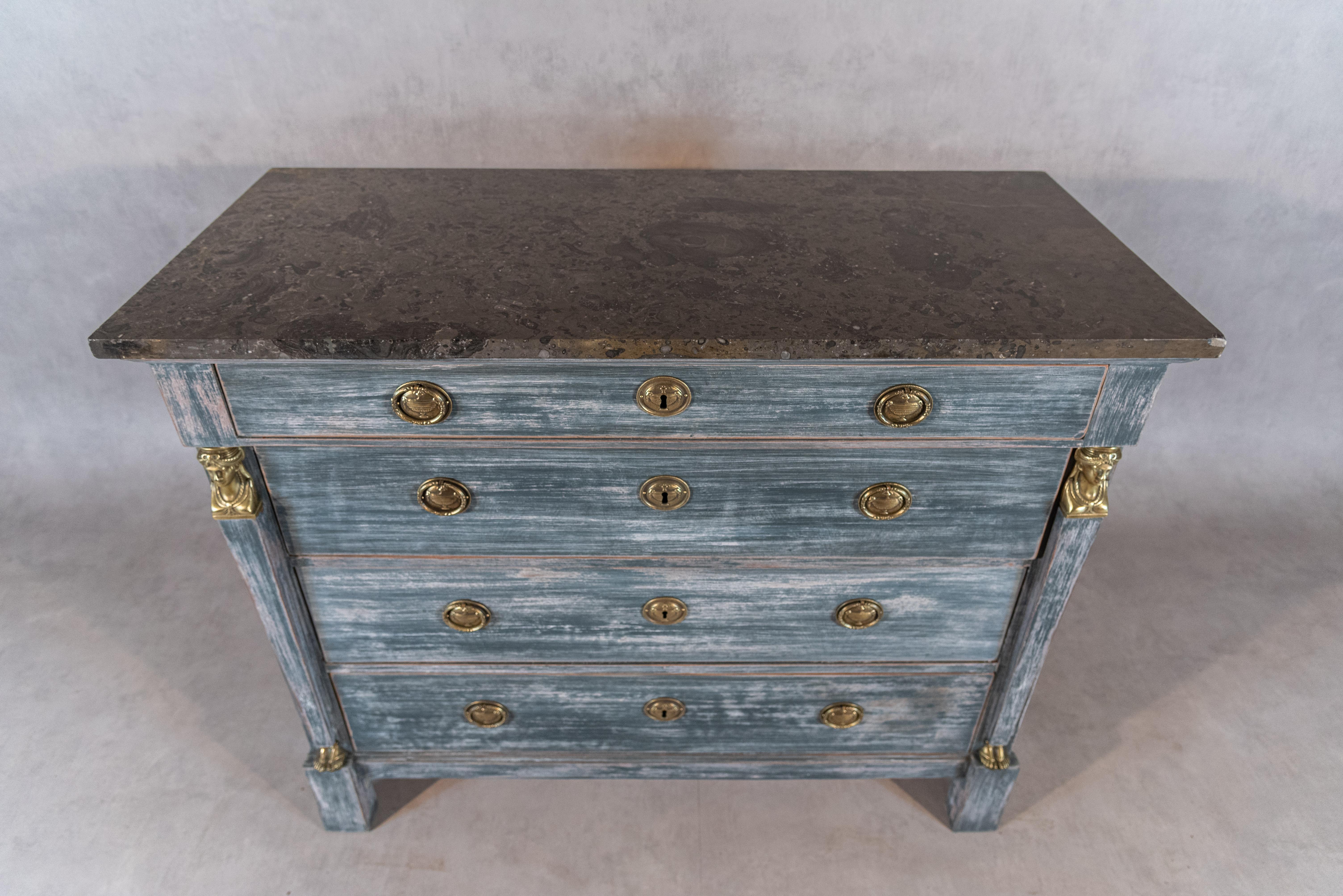 Step into the fascinating world of the French Egyptian Revival Period with this gorgeous commode, a stunning piece that reflects the allure of ancient Egypt. The commode's unique patina adds a sense of history and character, telling a story of its