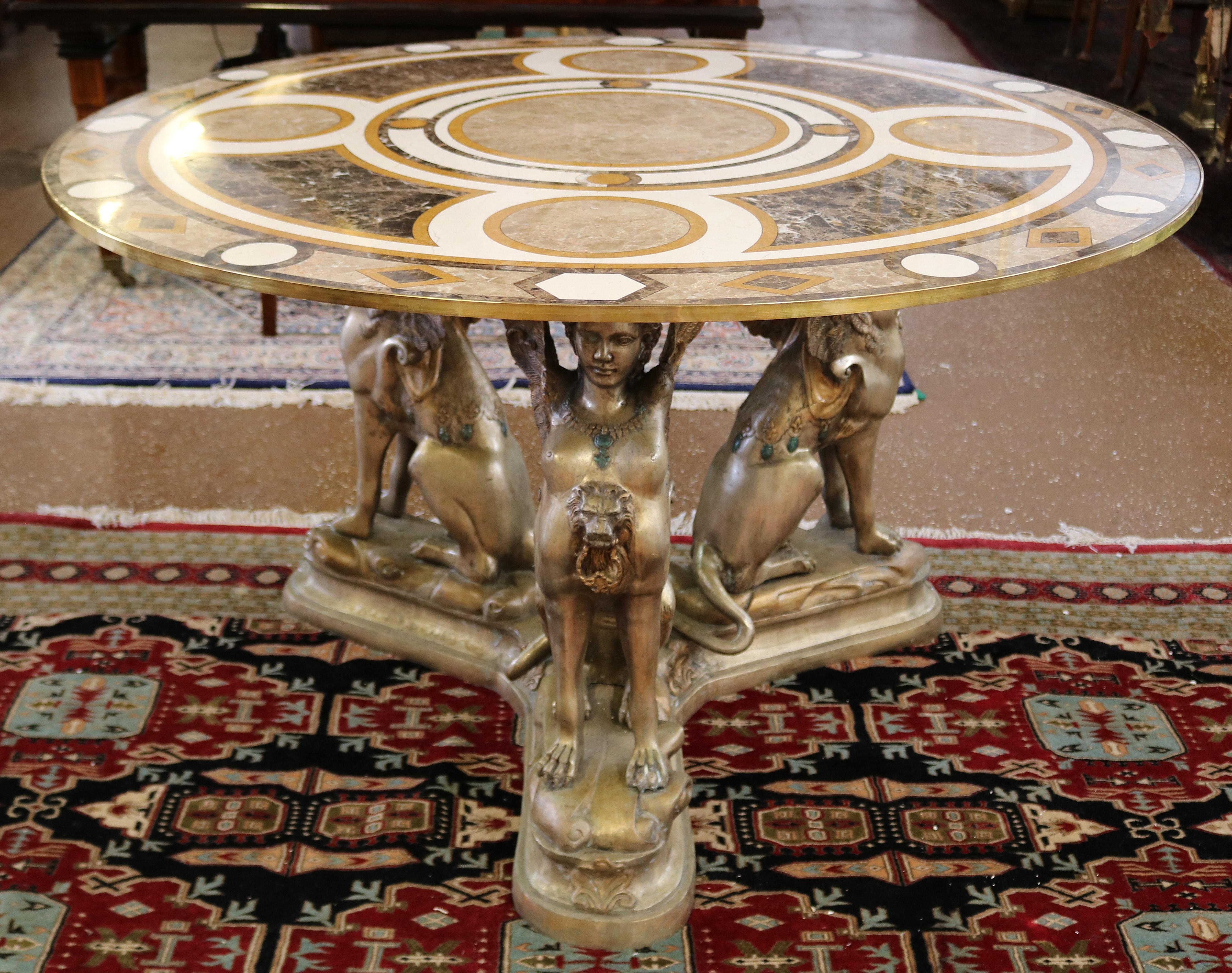 French Egyptian Revival Style Bronze & Marble Veneer Pietra Dura Top Center Table

Dimensions : 48 X 48 X 29

This stunning veneered inlaid marble top bronze table is after the model by Val D'Osne a foundry in France most famous for the Paris