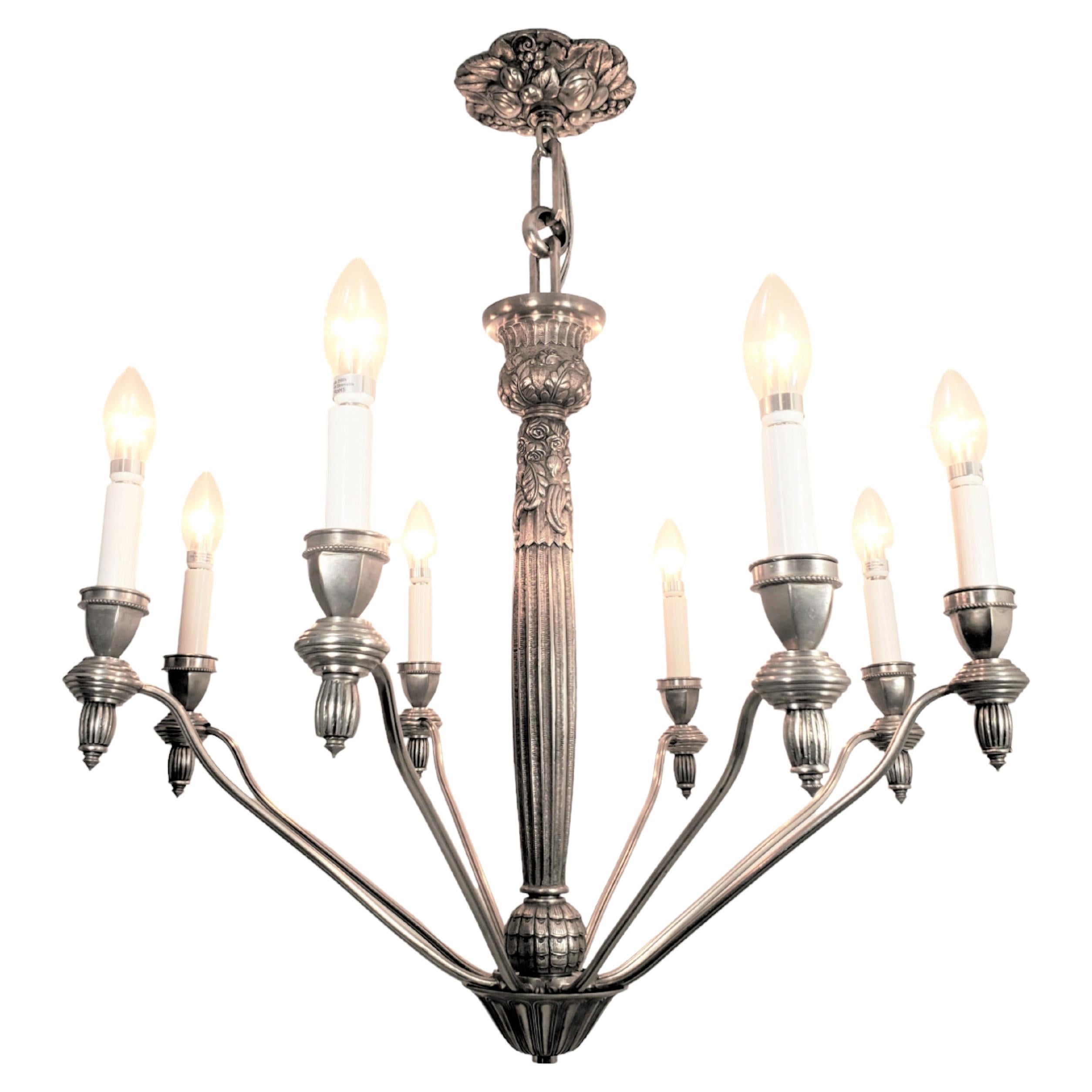 Fine and exquisite original French chandelier boasts eight beautifully cast, heavy nickeled bronze arms, each suspended gracefully by a central reeded stem. Every arm is adorned with angular bobeches, showcasing a delicate beaded edge just beneath