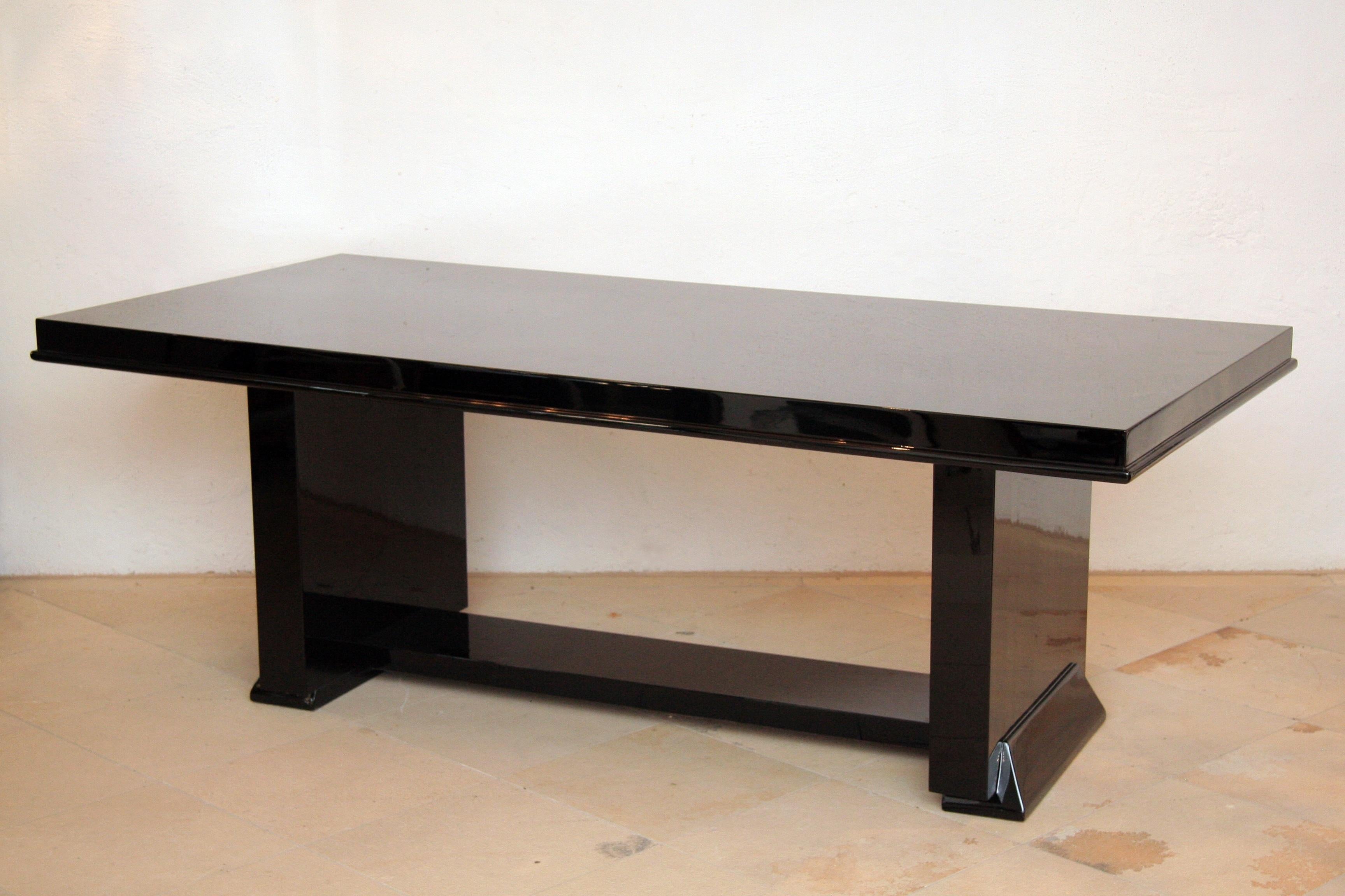 Elegant cubistic shaped Art Deco dining table or desk.

The object is strictly cubic and clear-lined, it captivates with its reduced design and 
thus appears elegant and sophisticated. 
The table top is accentuated a bit by a profile strip running