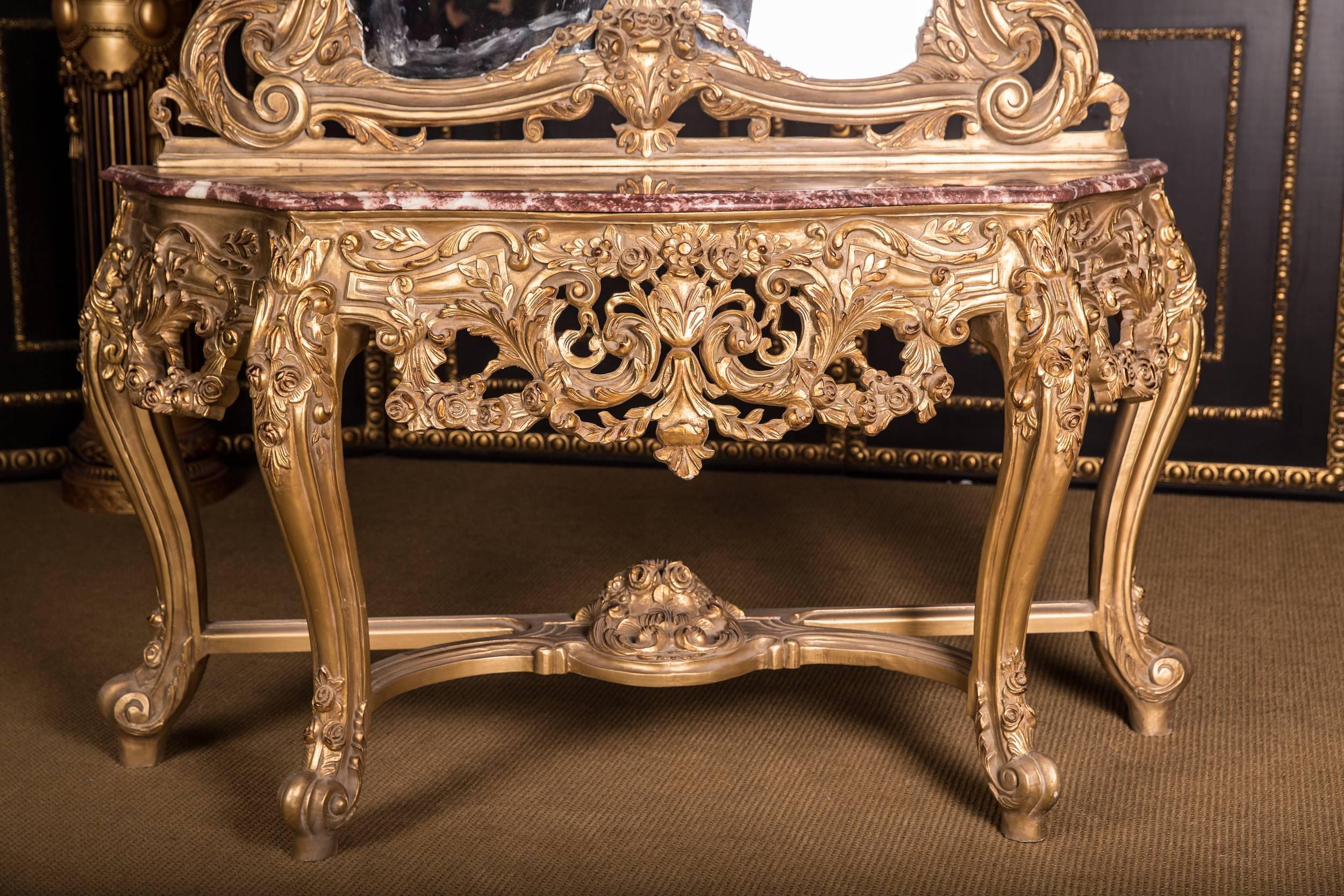 Solid beechwood, finely carved and set. On short obliquely curled volute-like curly feet. Three-sided scalloped crowned frame, rich acanthus and Rocailleschnitzereien. Overhanging marble slab. On top of scrolled volutes and central carving. High