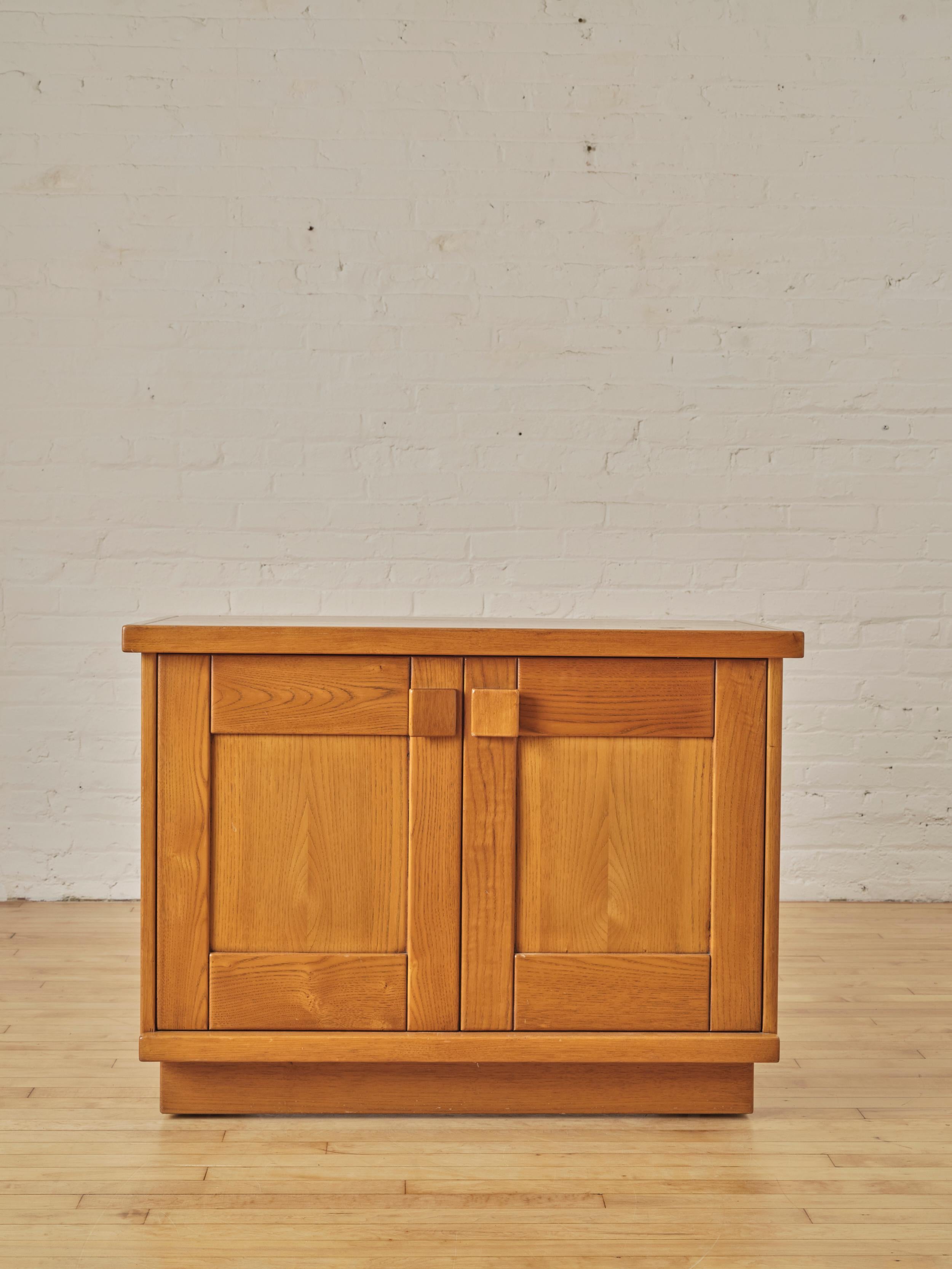 French Sideboard by Maison Regain in elm wood, featuring three doors with sculptural pulls that open up to reveal single shelving.

