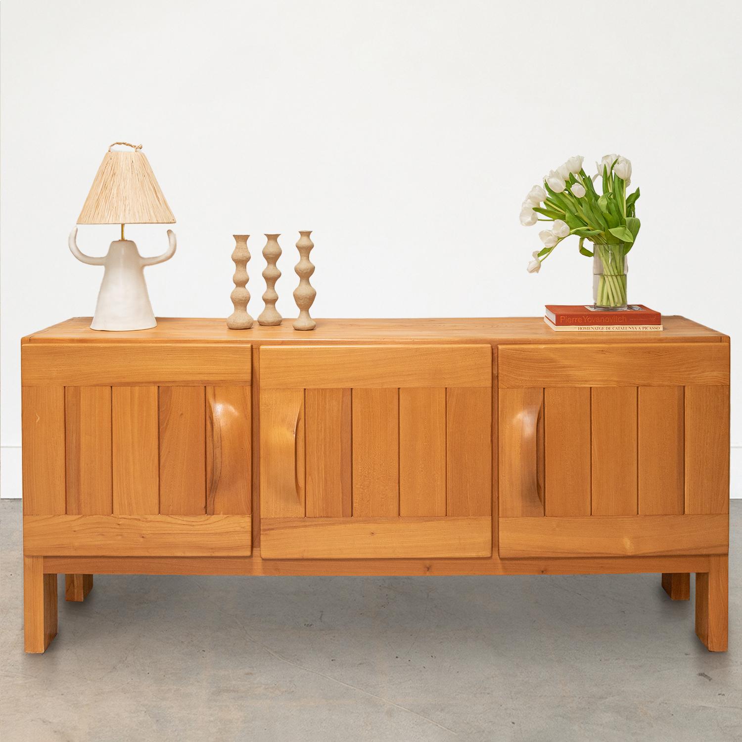 Great vintage credenza by Maison Regain from France, 1970s. Made of solid elm wood with three doors opening to a single shelf in two compartments and three drawers in the right side compartment. Original finish in very good condition.