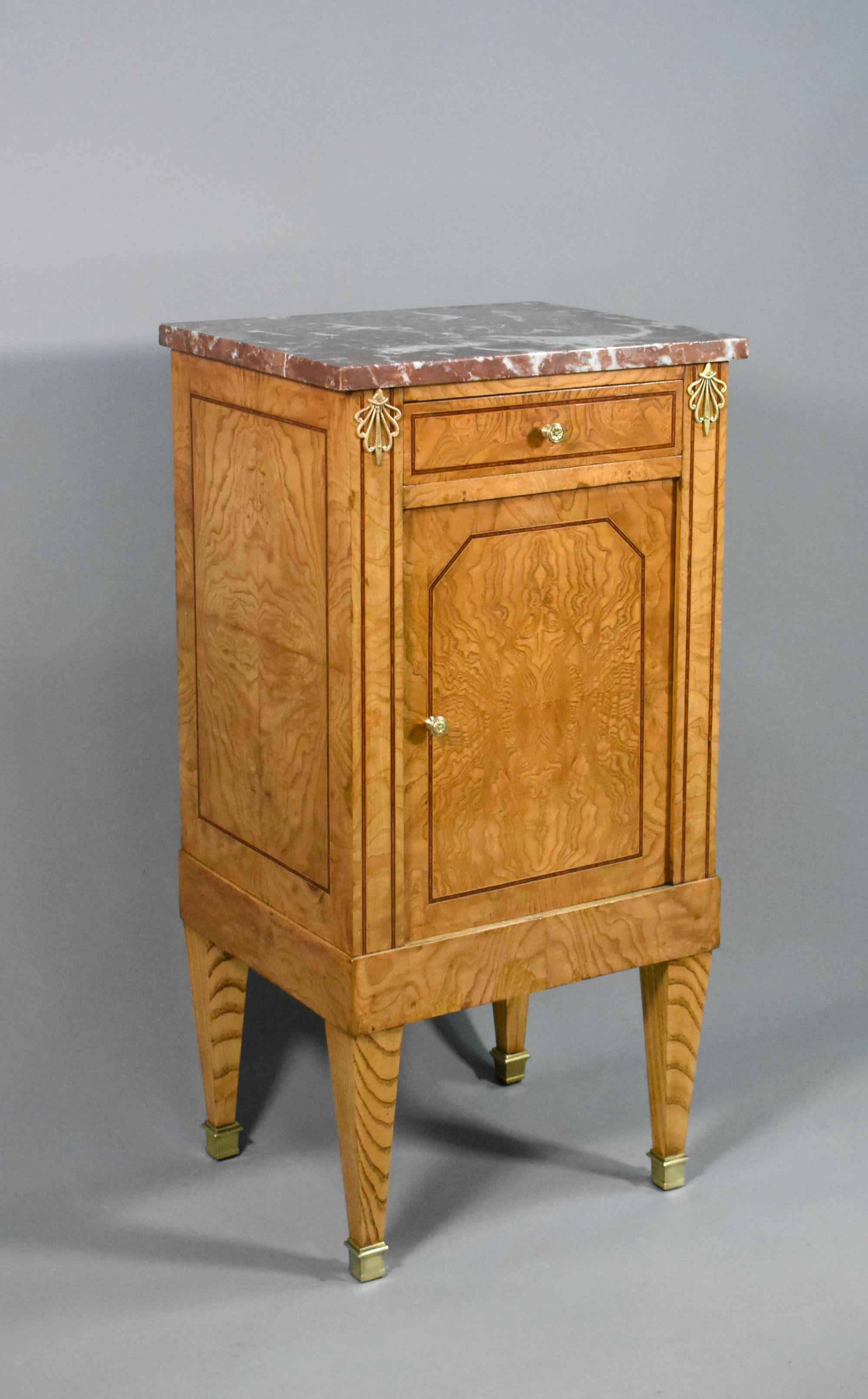 French Elm & Marble Cabinet Louis XVI Style 

A striking cabinet featuring a variegated red, white and grey fixed marble top and increasingly rare elm veneered panels. 

The wood is a lovely light colour throughout with distinctive patterns to the