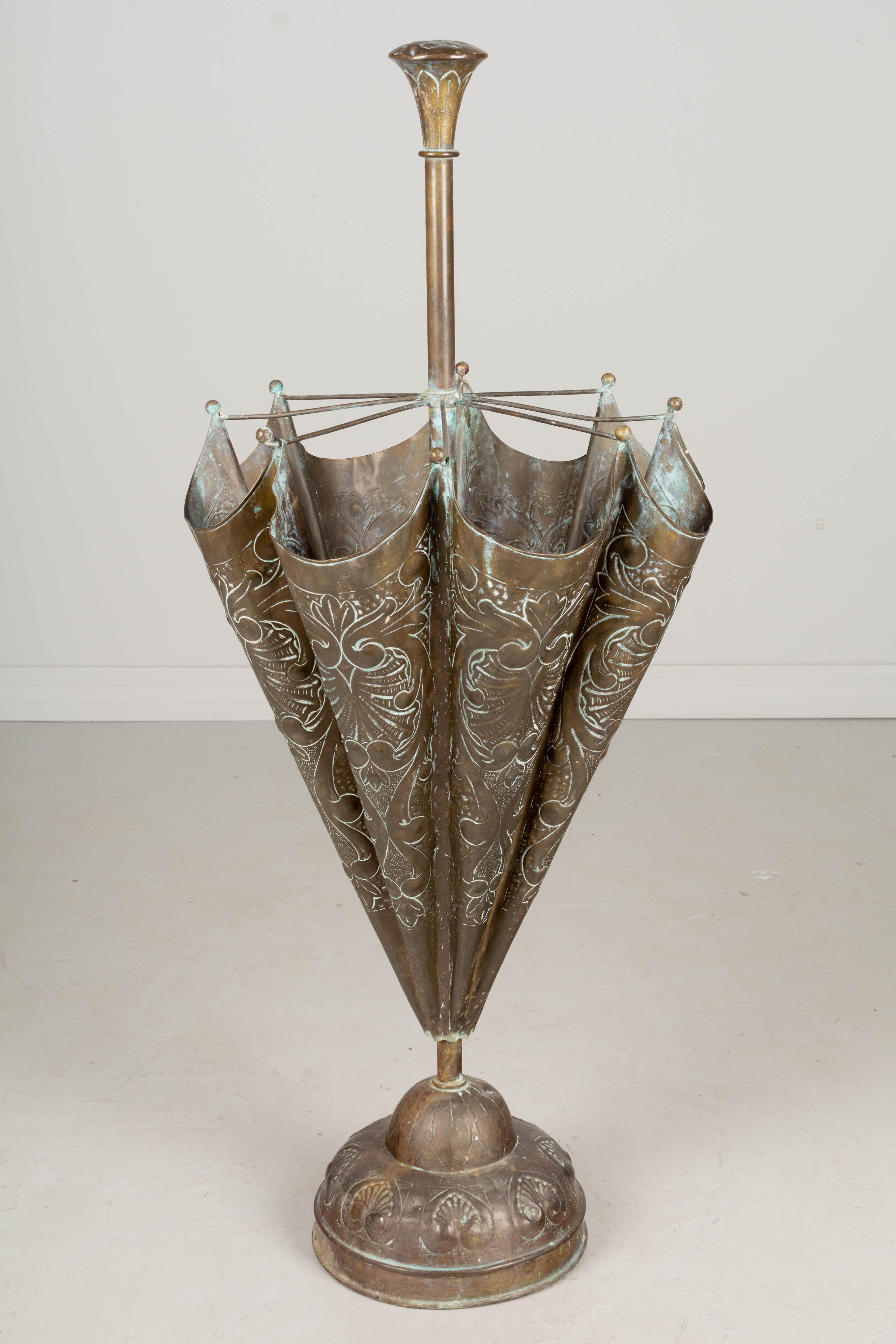 A French embossed brass umbrella stand with nice verdigris patina. Minor dents. Circa 1900. 40