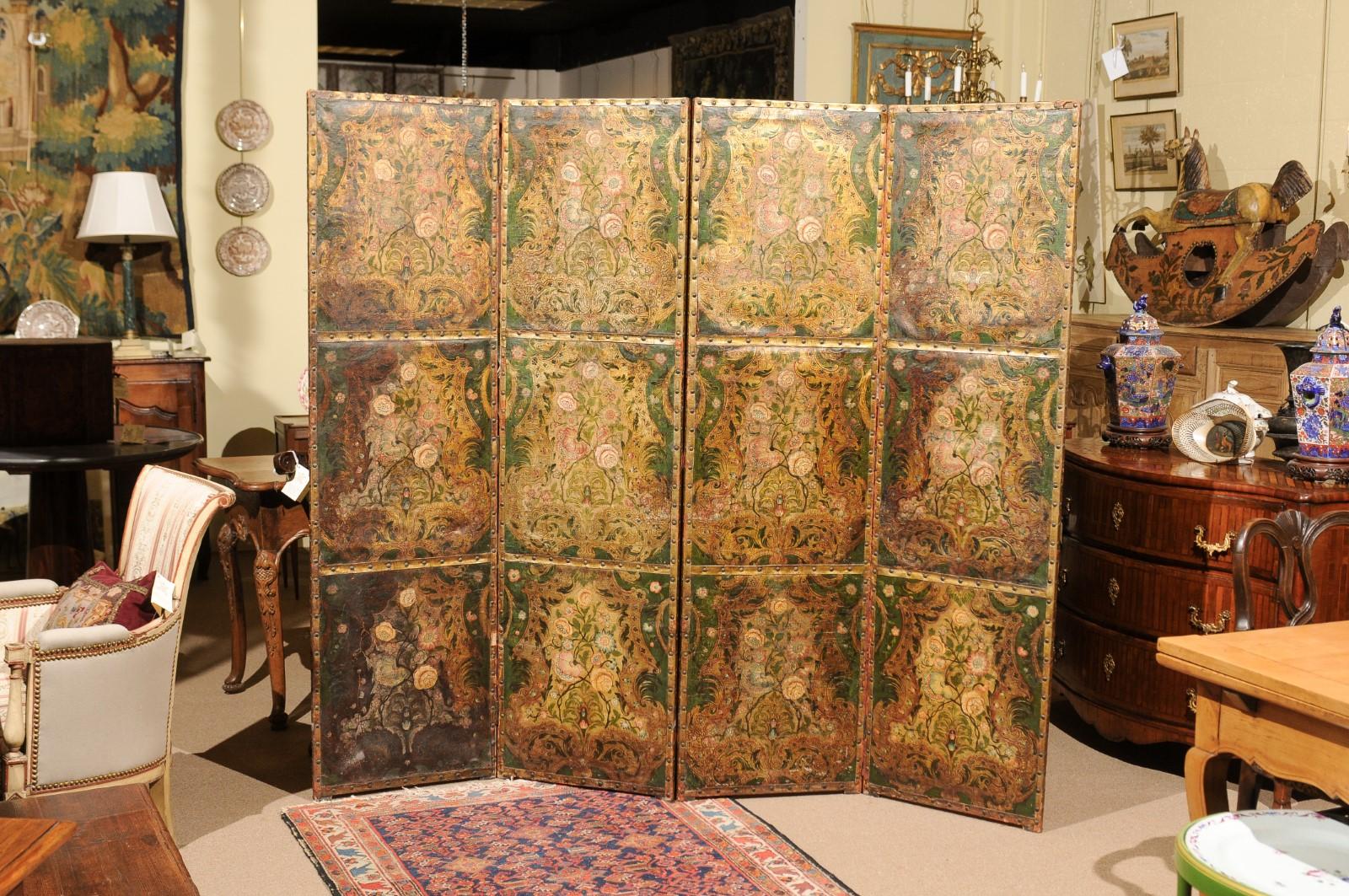 The French embossed leather 4-panel screen with painted floral design in dark green, rose, blue and gilt hues.