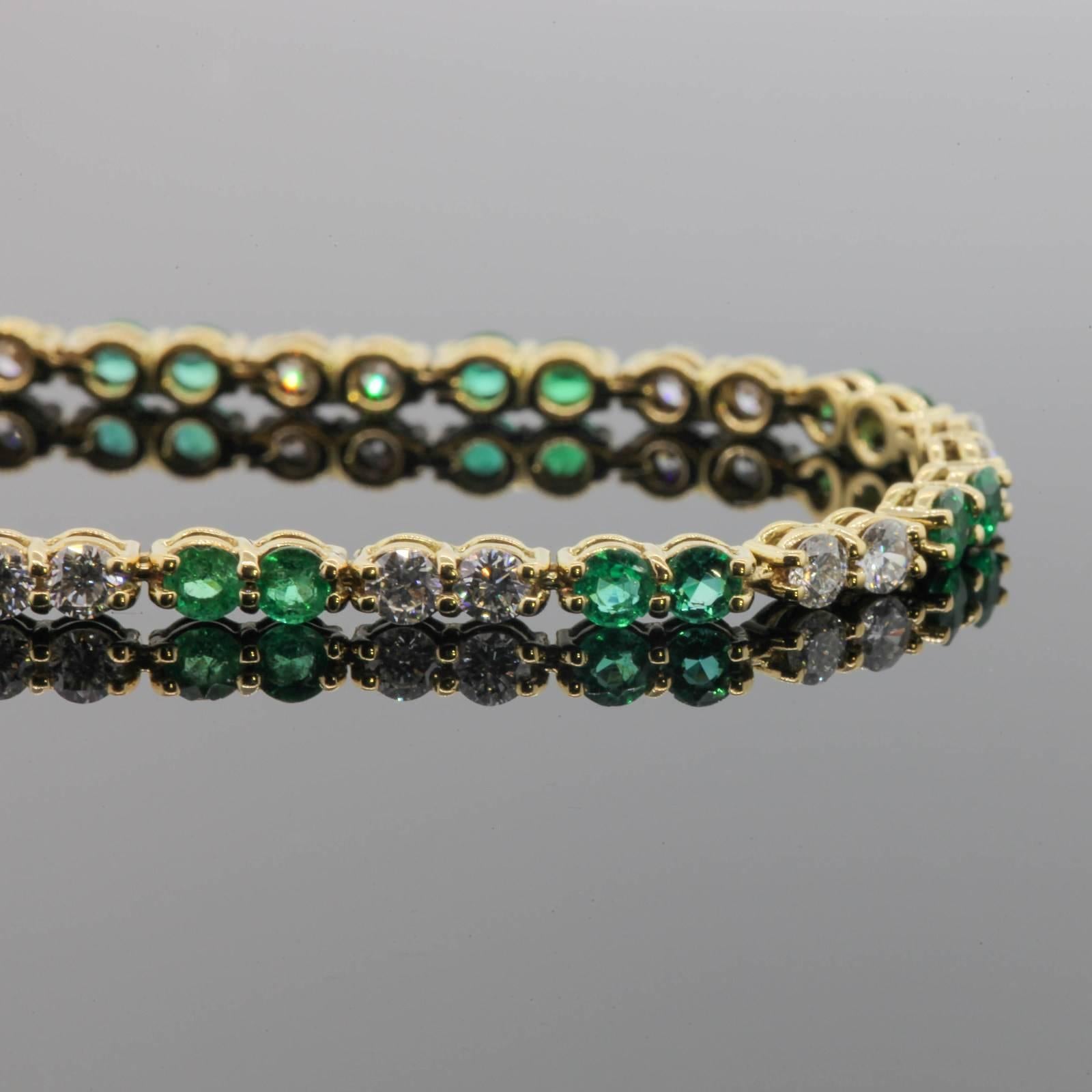 This bright happy 18KT yellow gold bracelet features 1.40 carats of Round cut Colombian Emeralds, and 1.70 carats of Round Brilliant Cut Diamonds.  All gems are set in double wire settings with common prongs.  The straight line bracelet measures 6
