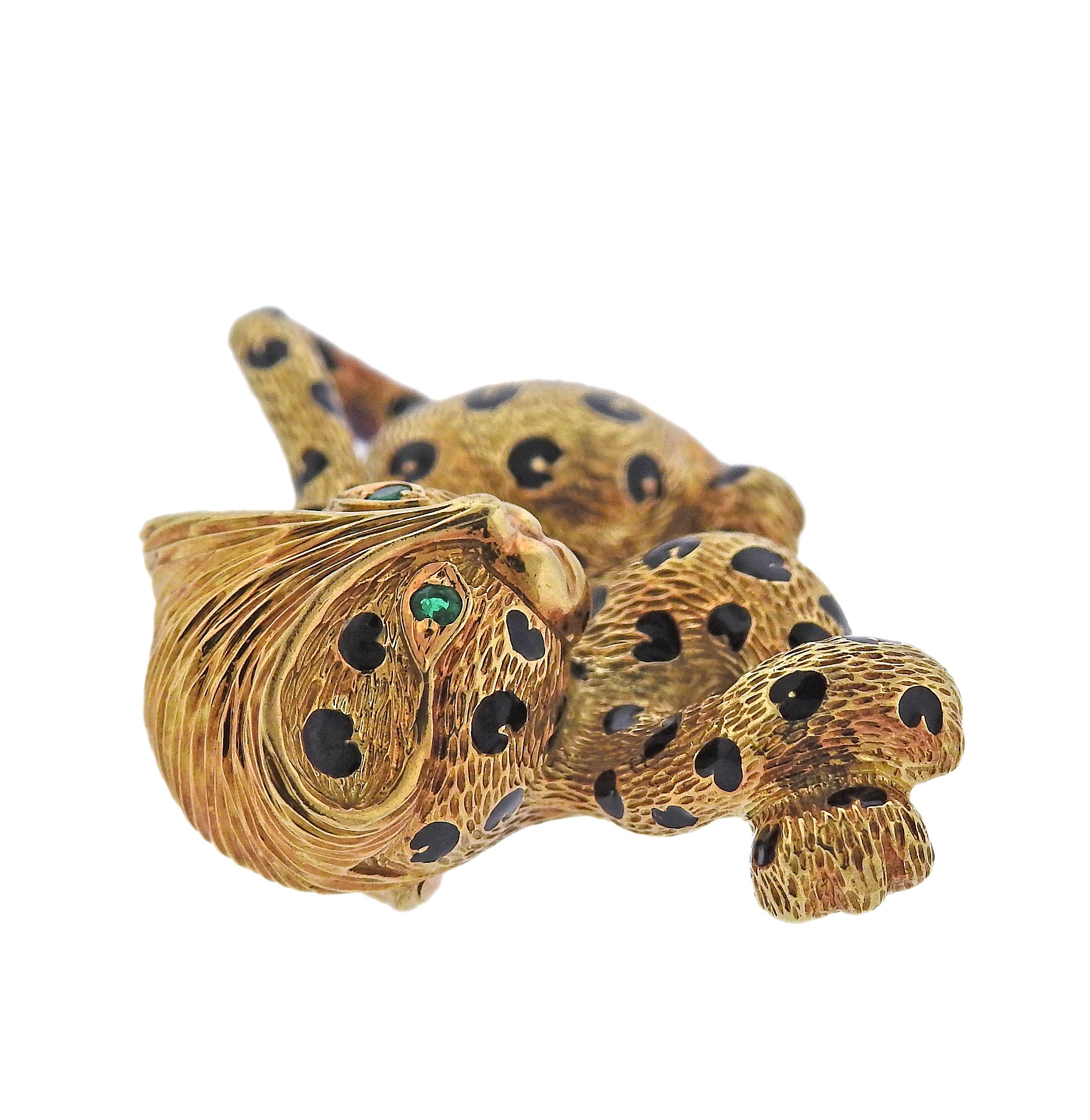 French made 18k yellow gold brooch of leopard featuring enamel and emerald eyes. Brooch is 45mm x 25mm. Marked 750 made in France. Weight is 17 grams. 