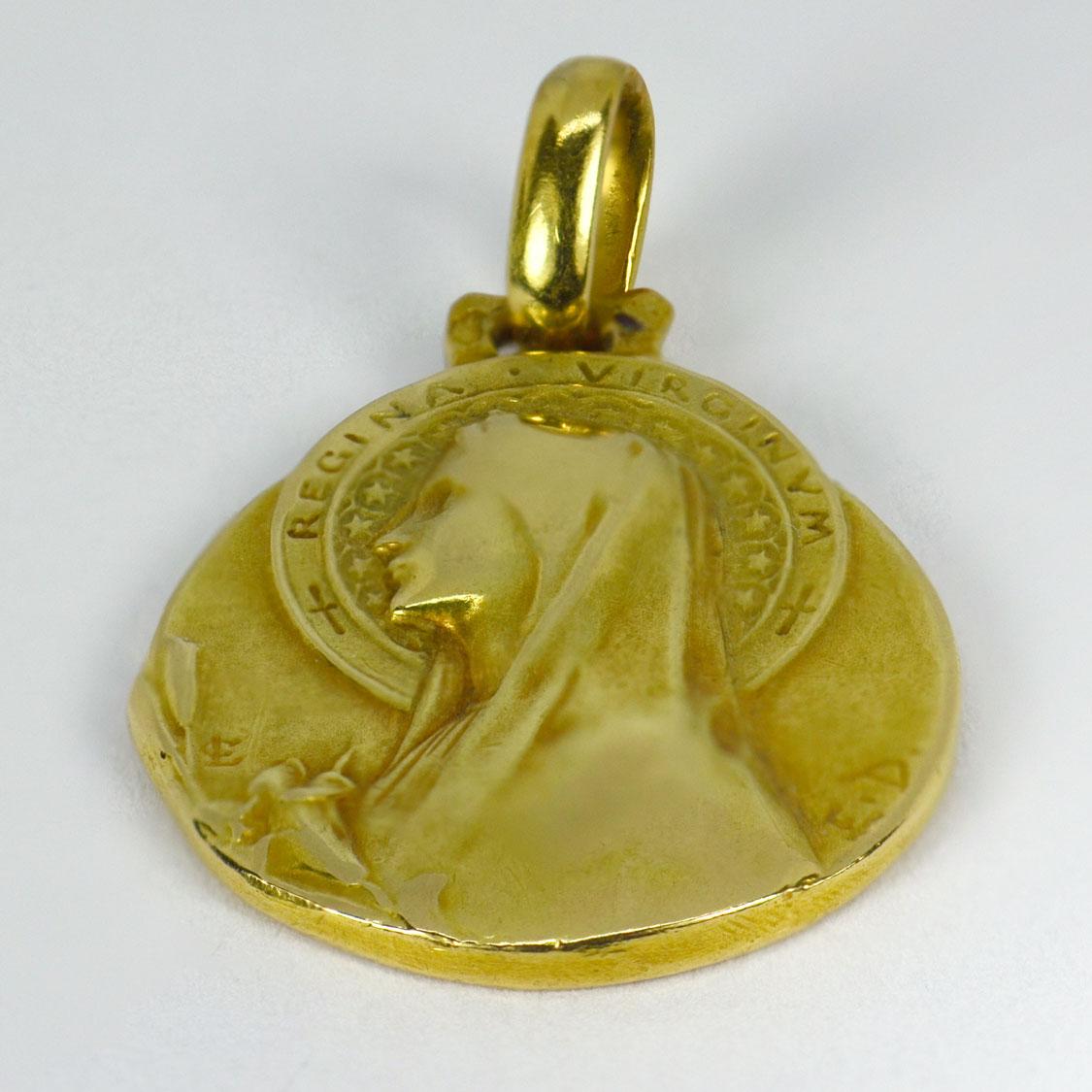 An 18 karat (18K) yellow gold pendant designed as a medal depicting the Virgin Mary with inscription ‘Regina Virginum’. Signed E.D for Emile Dropsy. Stamped with the eagle’s head for French manufacture and 18 karat gold and engraved ‘Paulette 16