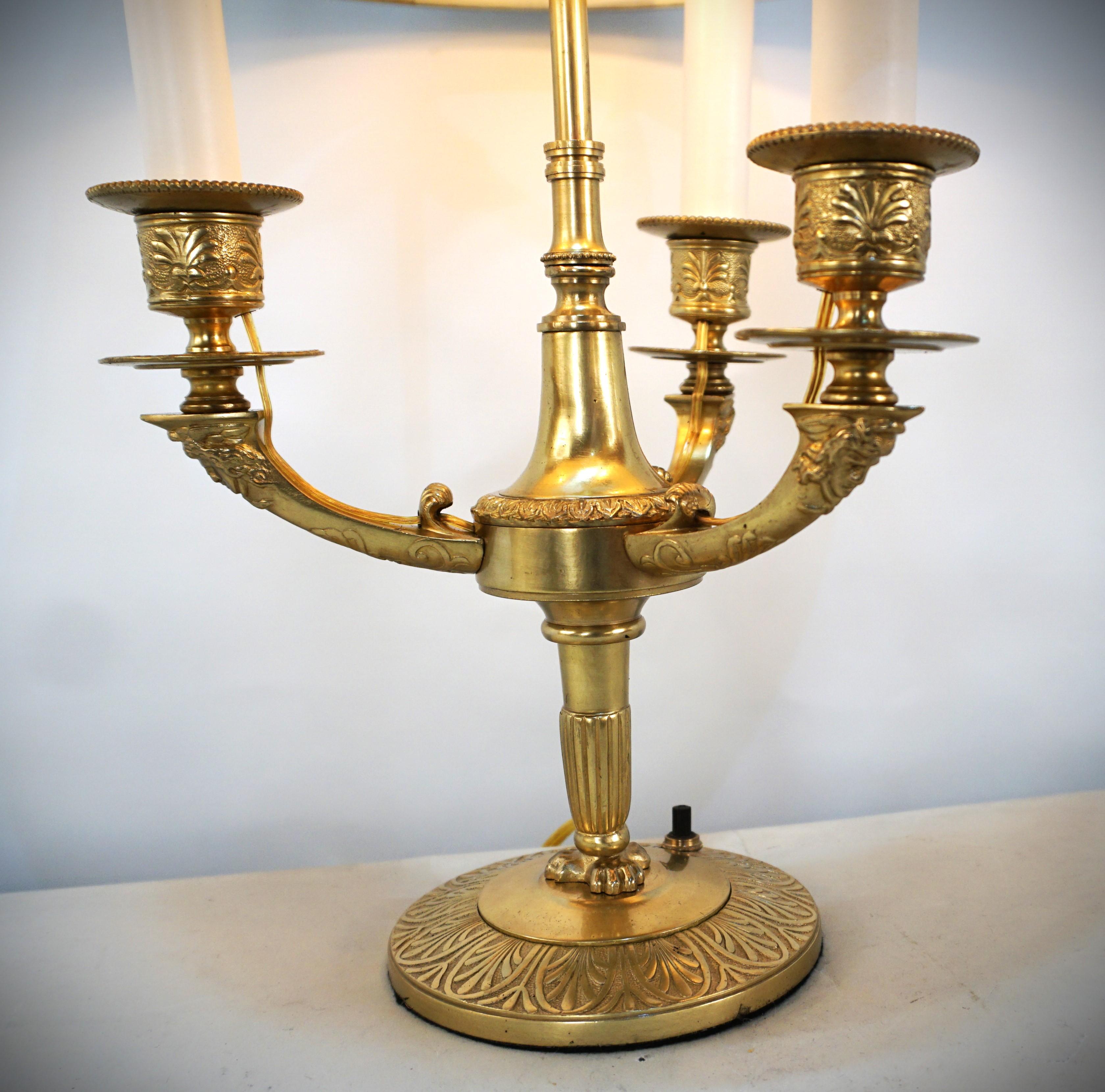 French bronze electrified candle desk lamp with adjustable shade.
Beautiful design with face on each arm and flam finial.
Professionally rewired.
  