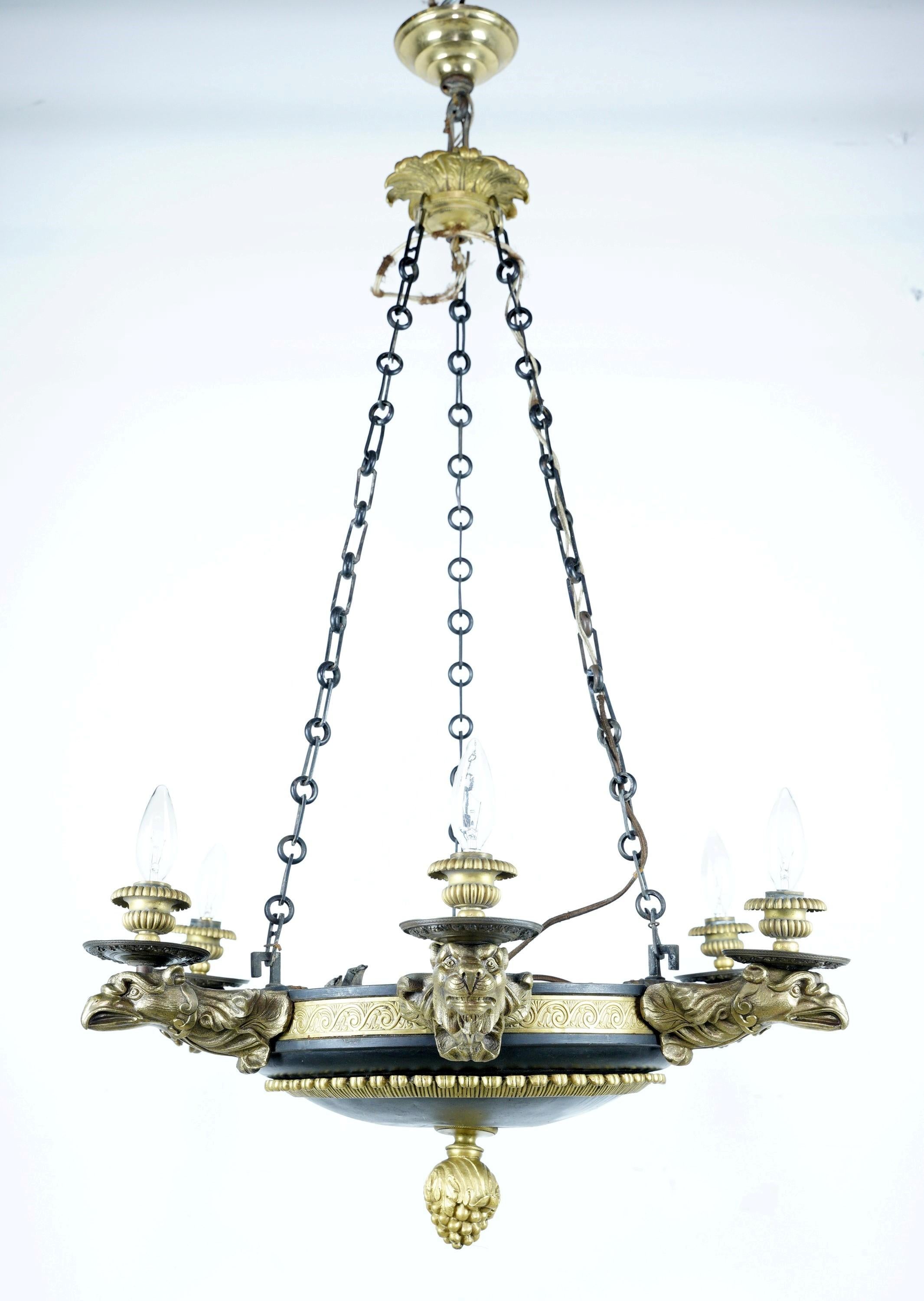 French Empire bronze chandelier with figural eagle, and lion head motifs on each arm, a pineapple motif and a black finish. Cleaned and restored. Please note, this item is located in our Scranton, PA location.