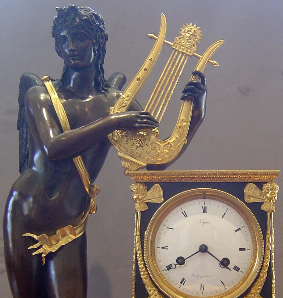 A fine, large and important French Empire clock of Apollo playing his lyre in patinated bronze, ormolu and antique vert marble. The dial is signed for the important maker Lepine and carries the motif above 6 o'clock 