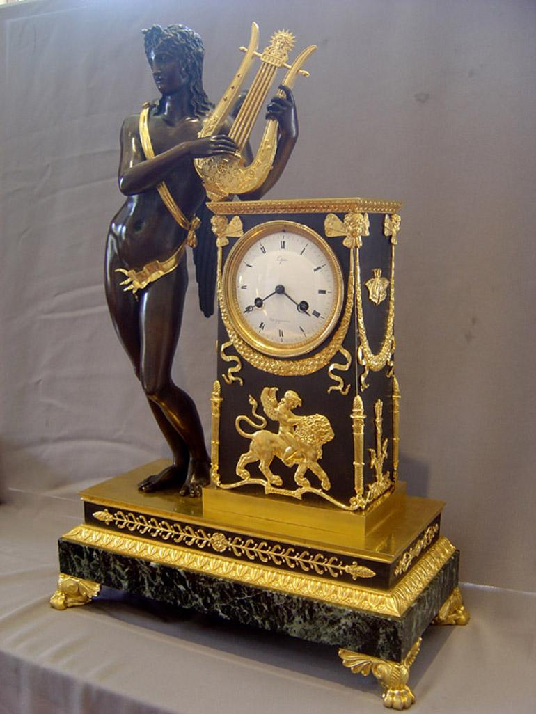 Bronze French Empire antique Apollo clock by Lepine and Rabiat. For Sale