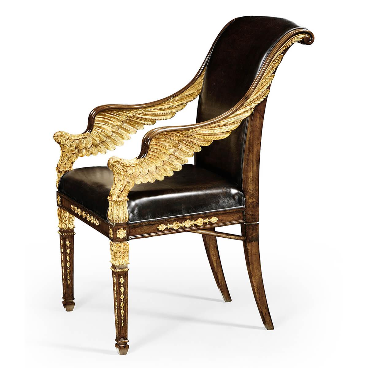 Impressive walnut and gilt Empire style armchair with finely carved golden wings to the arms and further carved gilt detail to the legs and seat rails. An antique caviar black leather upholstered back and seat. After French designs of the early 19th
