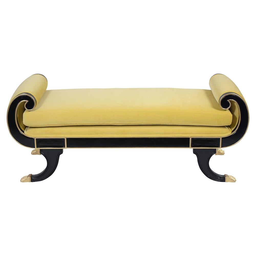 A fabulous 1950's Empire Bench handcrafted out of mahogany wood, has a newly ebonized color with eye-catching gilt molding accents making this piece outstanding. The bench also has scroll arms and carved legs with the gilt claw foot. This bench
