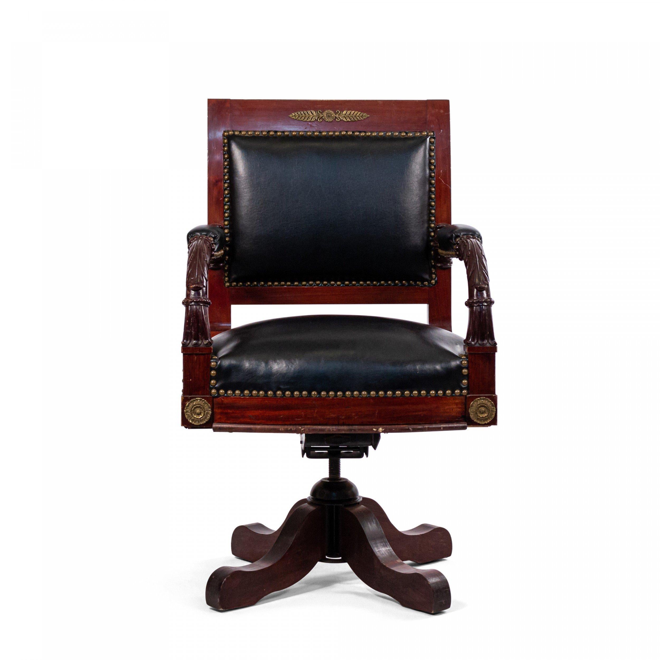 19th Century French Empire style ormolu mounted mahogany open swivel base arm chair with black leather seat and back.