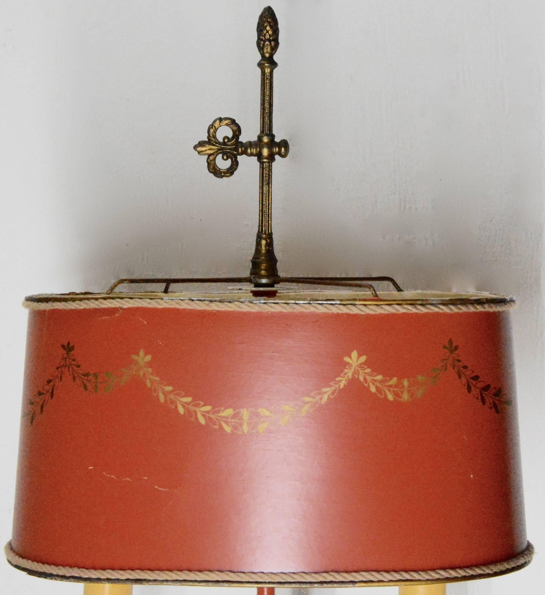 This is a lovely tole lamp that will enhance the decor of your home. It is finished in an orange tone with gold highlights. Two standard sockets will give you ample lighting. The shade is made of a heavy paper that is finished off with a rope trim.