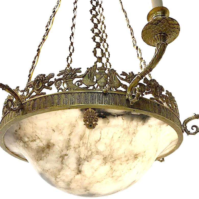 A French circa 1900 cast and gilt bronze seven-light chandelier with alabaster base.

Measurements:
Diameter 28