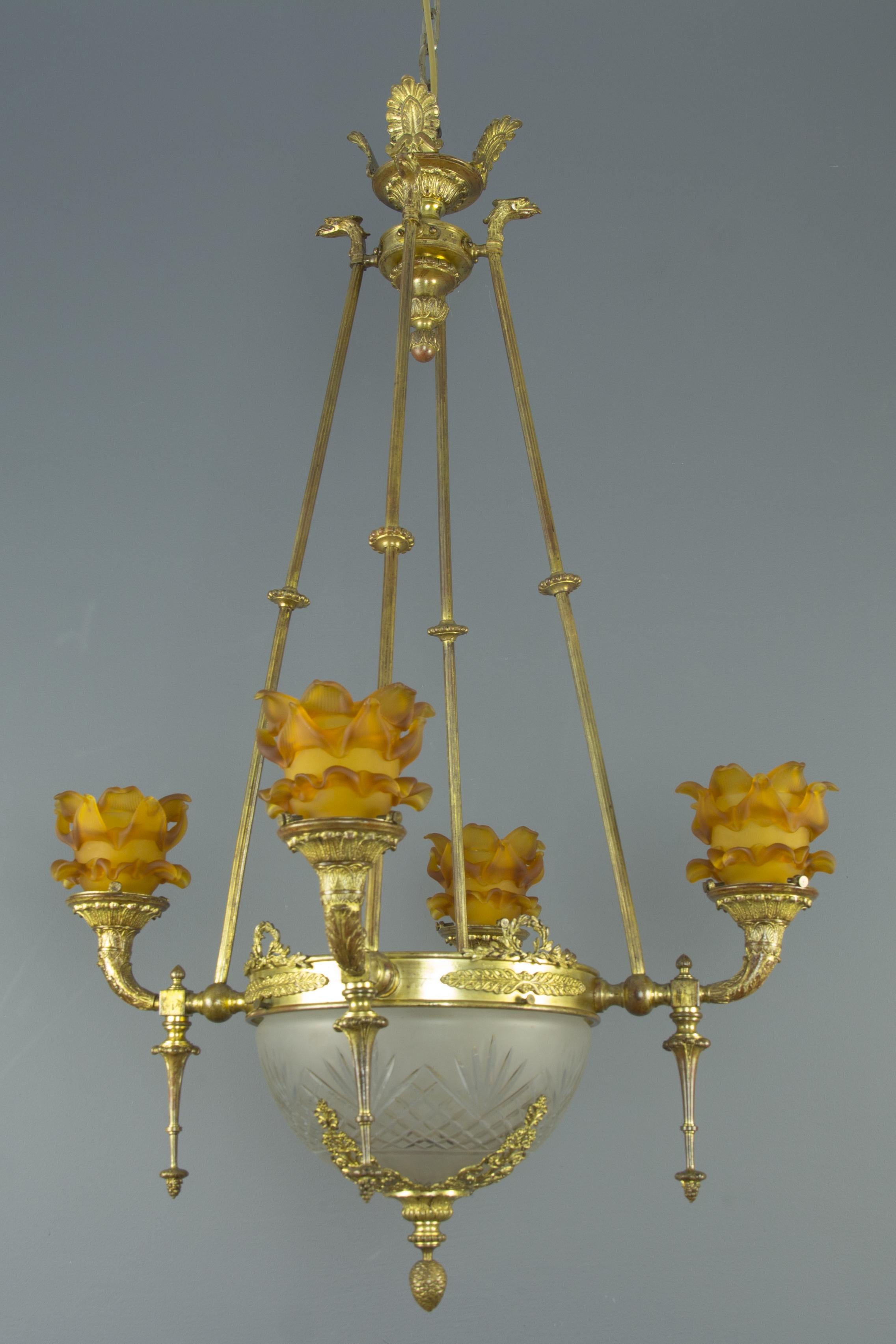 Stunning Empire style eight–light chandelier, surmounted by bronze corona with lotus palmettes. Four branches with griffin heads on top are supporting the central circular ring, decorated with palmettes and laurel wreathes. Four bronze branches,