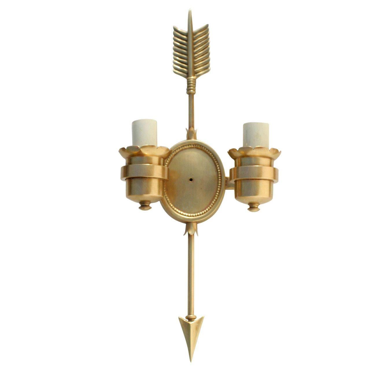 Pair of classic French Empire styled bronze sconces with decorative arrow. The two arms of the sconce feature scalloped edging.


             