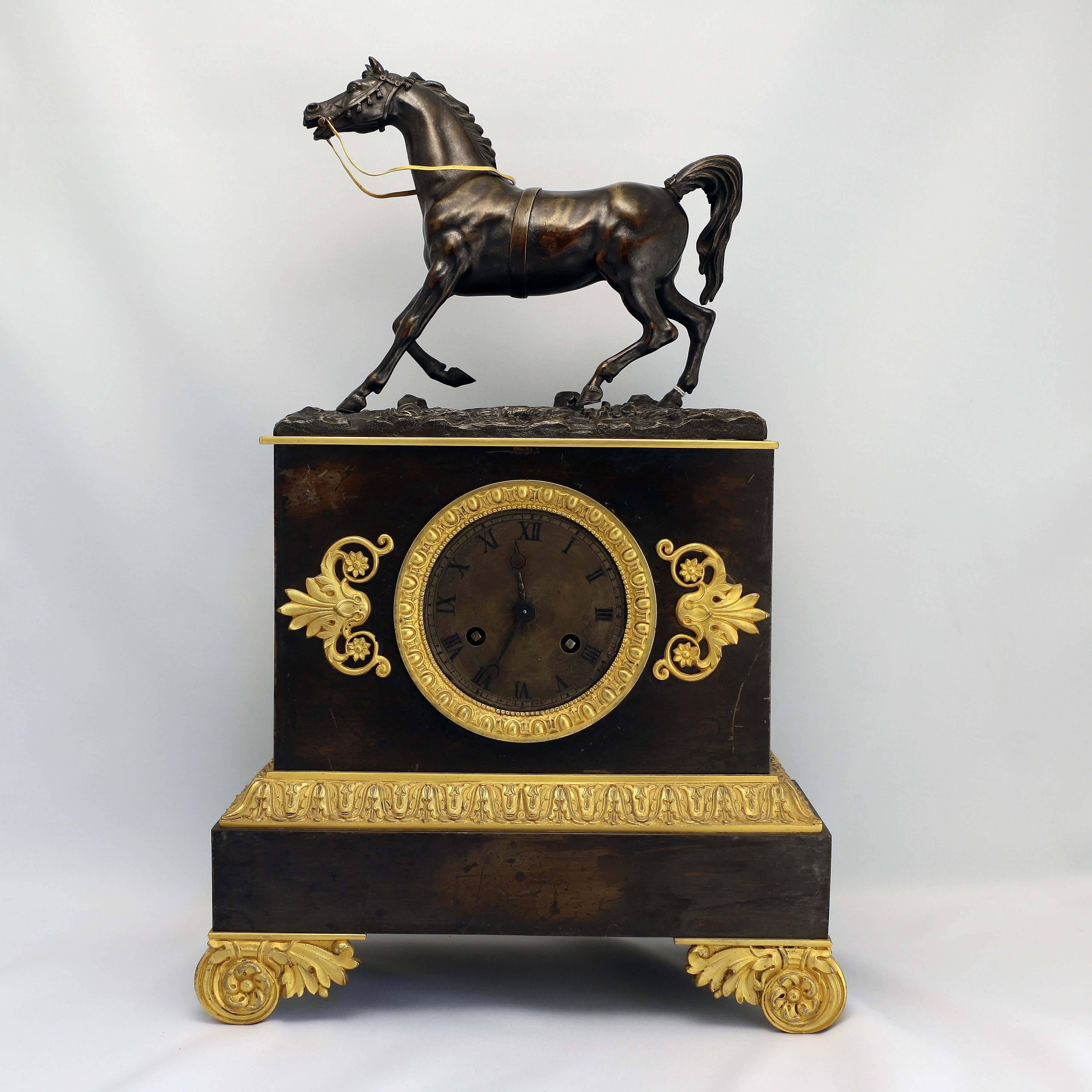 This handsome clock, with bronze case and crisp gilt mounts, adds an elegant accent to any room. Unusually it is surmounted by a bronze model of a thoroughbred. We have left the silvered dial with Roman numerals in original condition. It has an