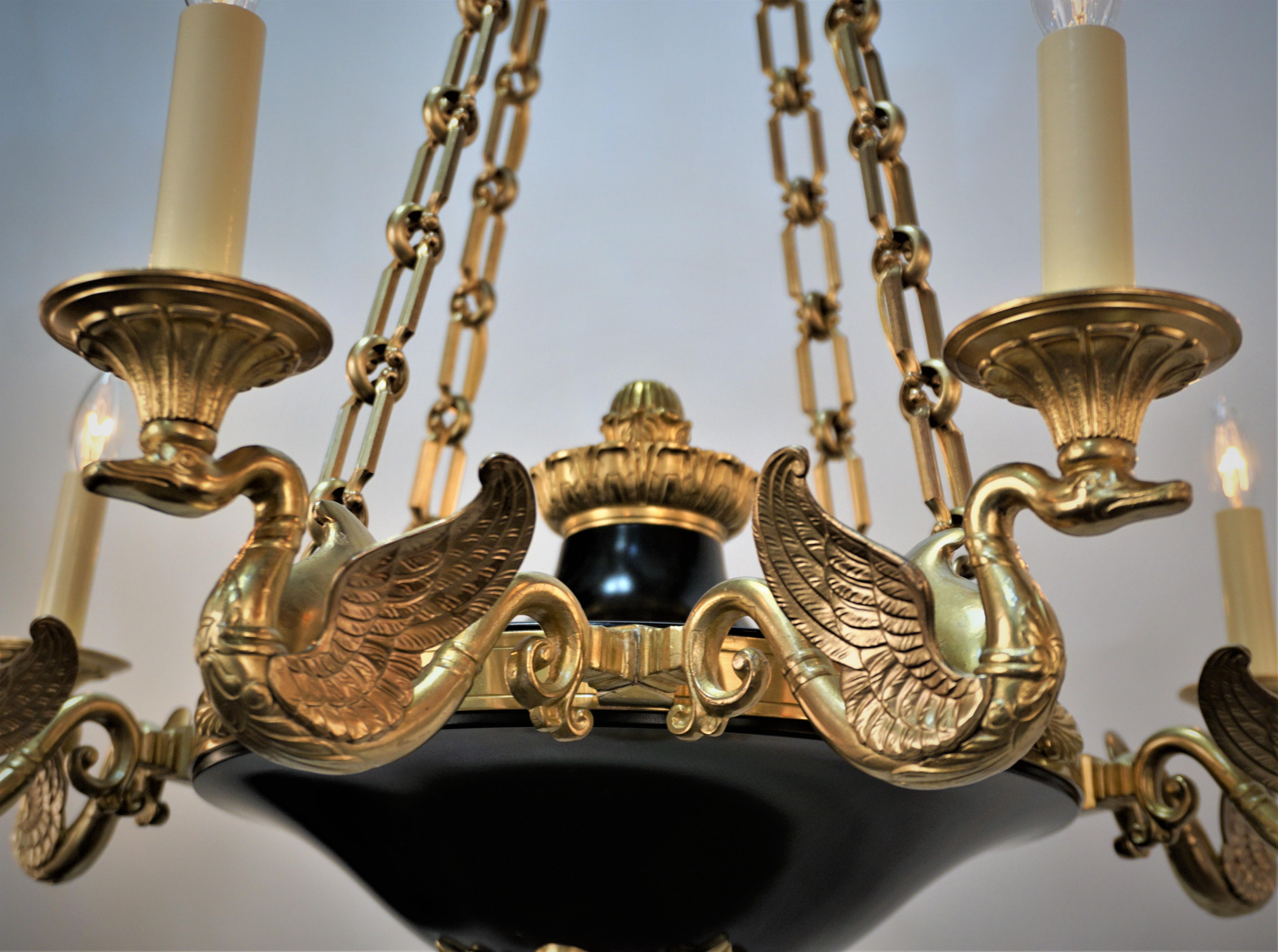French Empire bronze and black enameled eight light open wing swan arms chandelier.
Professionally rewired and ready for installation.