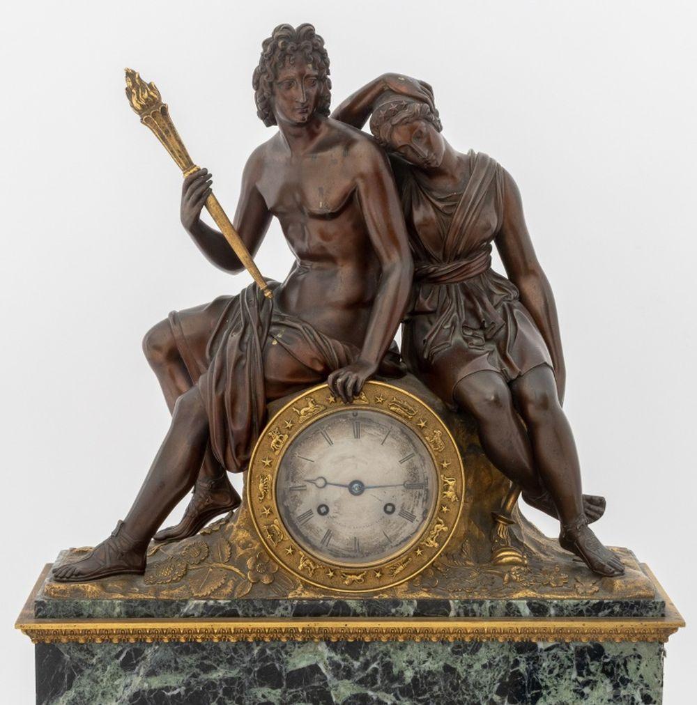 French Empire Patinated and Gilt Bronze Verde Antico Marble Figural Clock, circa 1830, the clock surmounted with seated figures of Apollo and Diana, each holding a torch, the clock with zodiac bezel, the silvered dial signed 