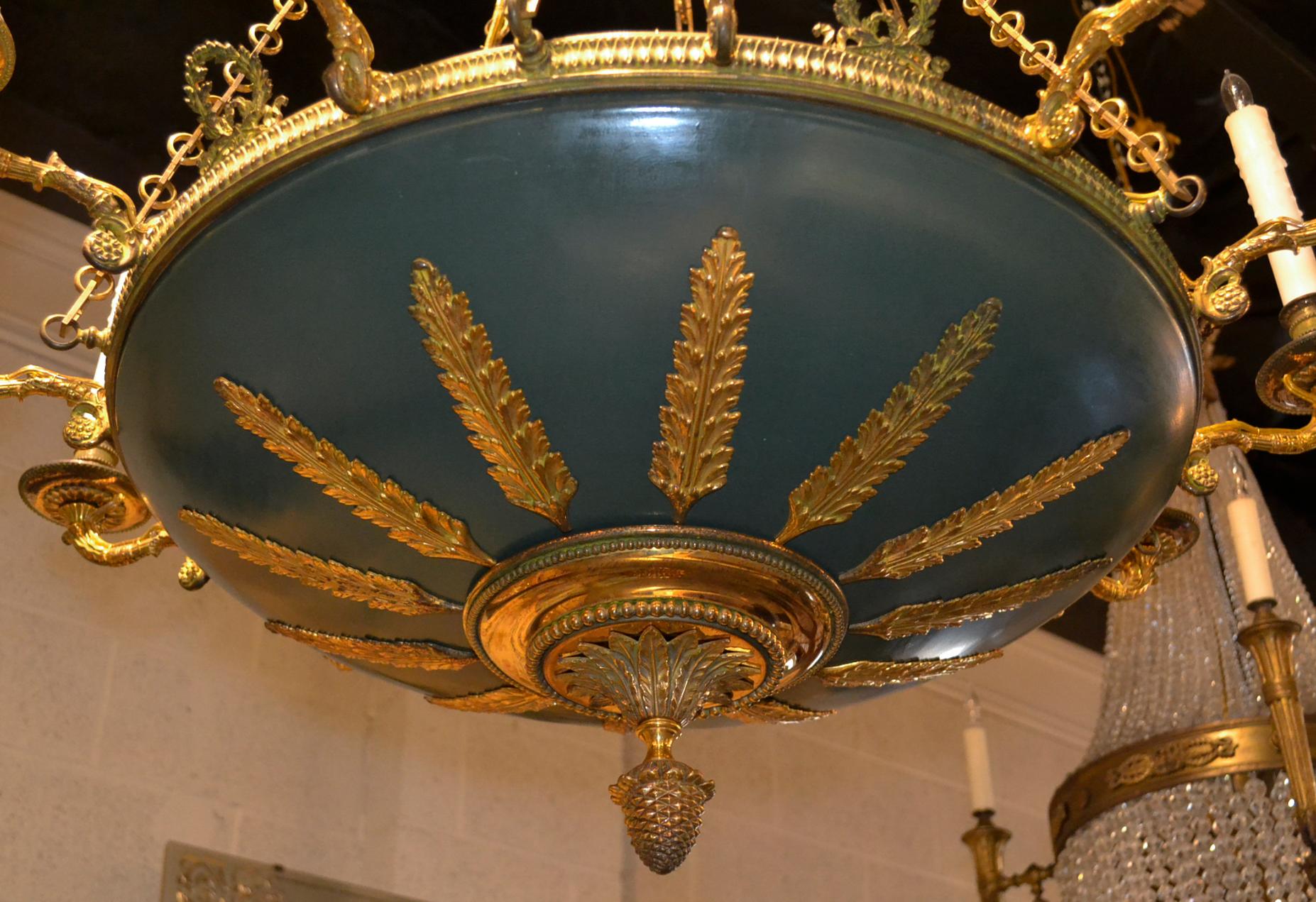 Excellent French Empire gilt bronze and tole 12-light chandelier.