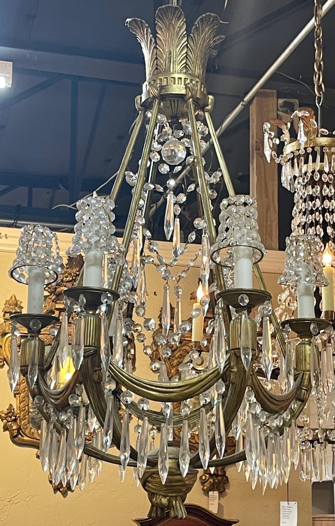 French bronze and crystal Empire style chandelier. Circa 1920. The chandelier has been professionally re-wired, cleaned and is ready to hang. Includes matching chain and canopy.