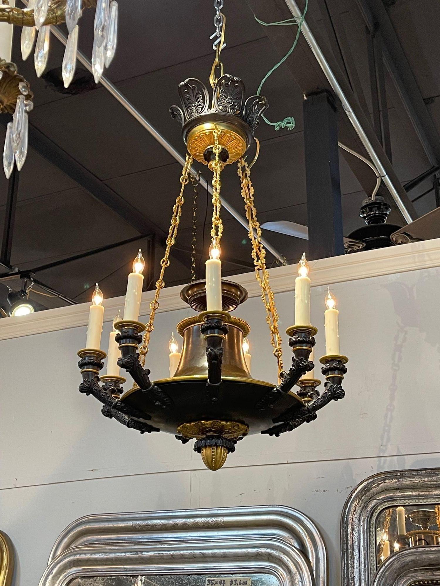 Fine quality 19th century French Empire gilt bronze 9-light chandelier. Circa 1870. The chandelier has been professionally re-wired, cleaned and is ready to hang. Includes matching chain and canopy.