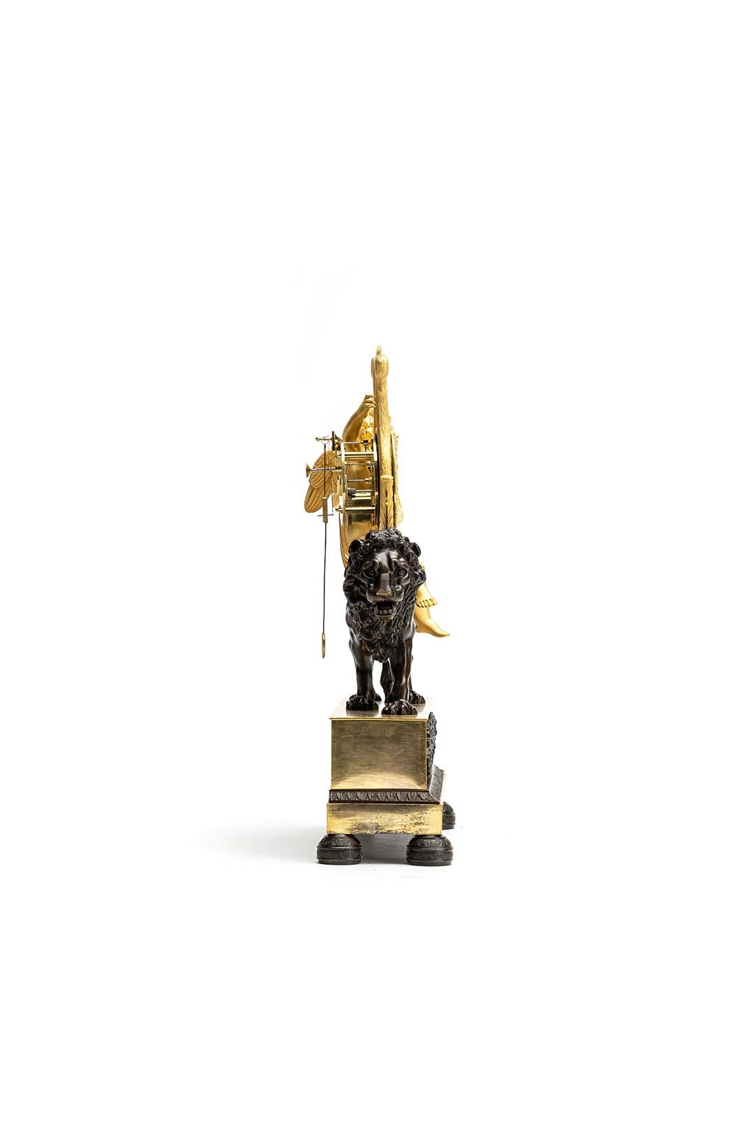 This is a beautiful French Empire/Charles X mantelpiece/pendulum from circa 1820 that is both unusual and charming. It features a lovely depiction of Cupido playing the harp on the back of a realistic-looking lion, creating a striking contrast with
