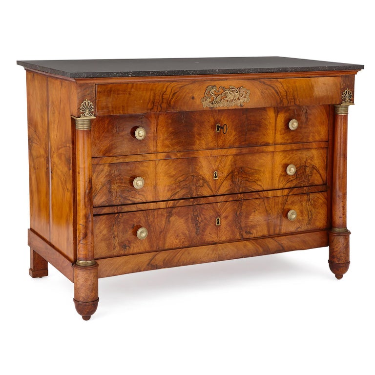 This beautiful walnut chest of drawers was crafted in France in the early 19th century. It employs classical ornament sparingly, and utilizes the color and grain of the walnut wood to create beautiful surface effects. 

The chest stands on four
