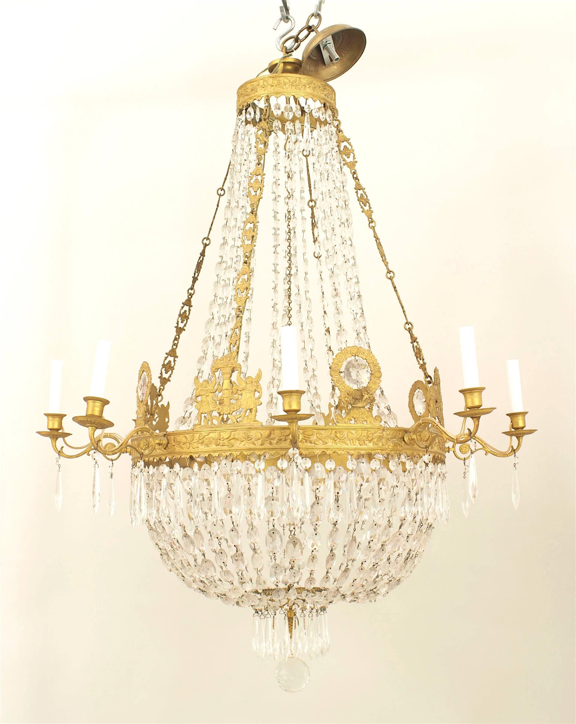 French Empire (circa 1810) gilt bronze and cut glass chandelier with cut crystal strands emanating from a gilt bronze center ring with 8 arms.
