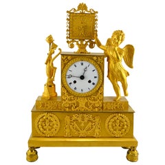 Used French Empire Clock Depicting a Standing Cupid and His Tools of Love