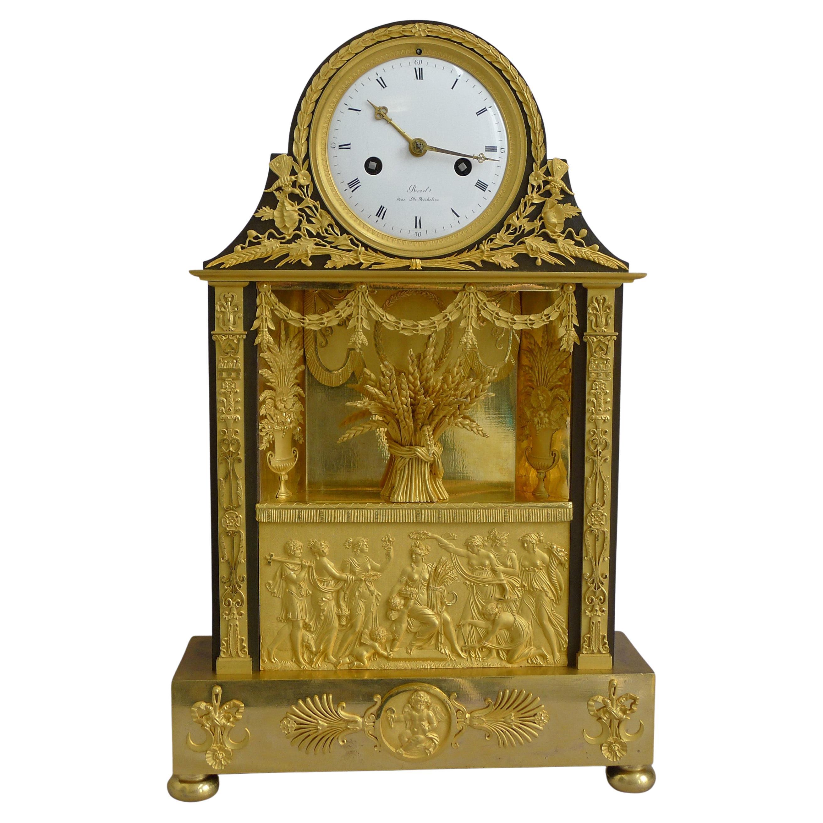 French Empire Clock in Ormolu and Patinated Bronze Signed Revel Rue De Richelieu