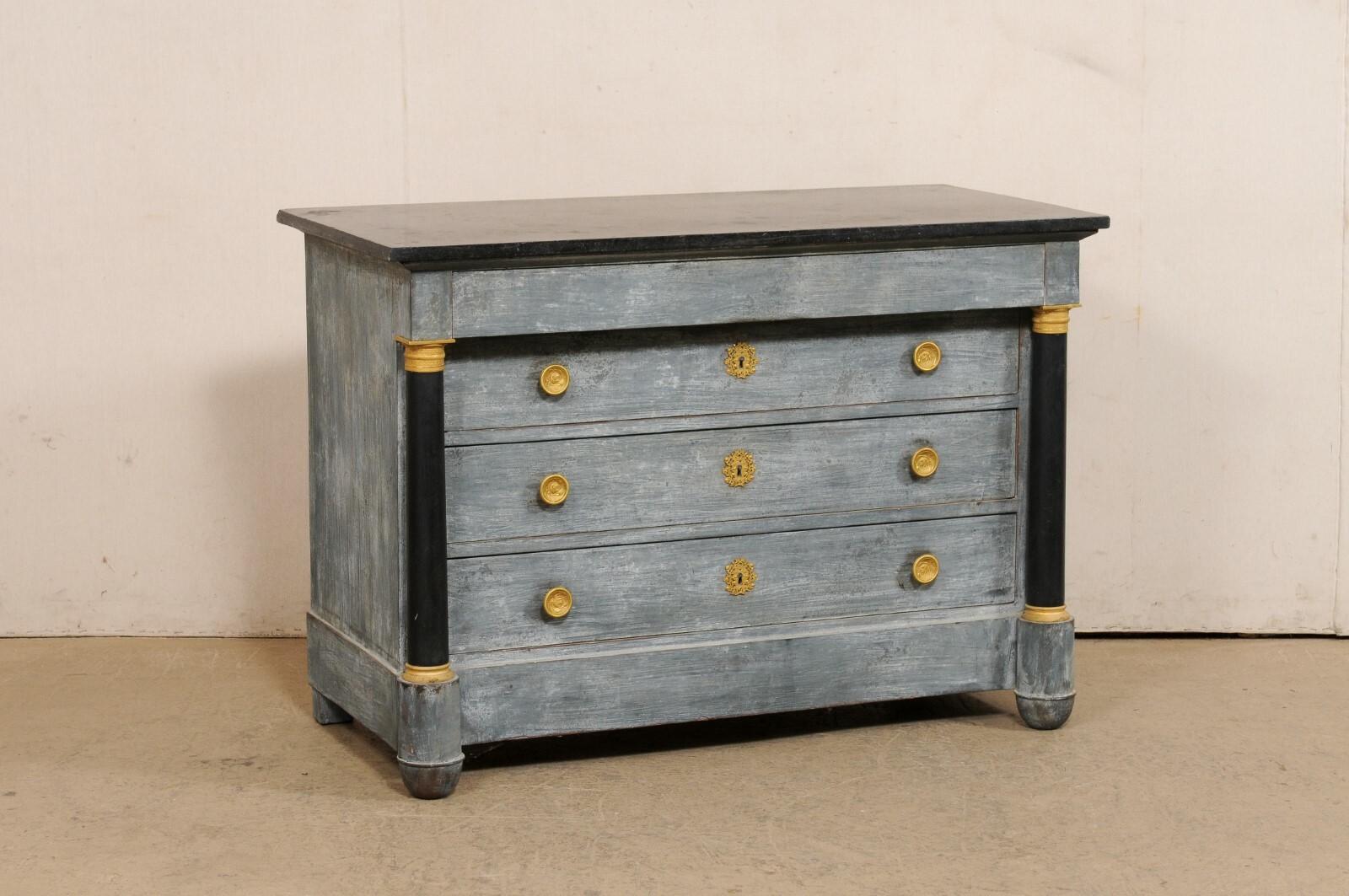 A French Empire painted commode, with marble top and brass accents, from the mid 19th century. This antique chest from France features a rectangular-shaped marble top which rests above a case which houses four graduated drawers (top drawer is hidden