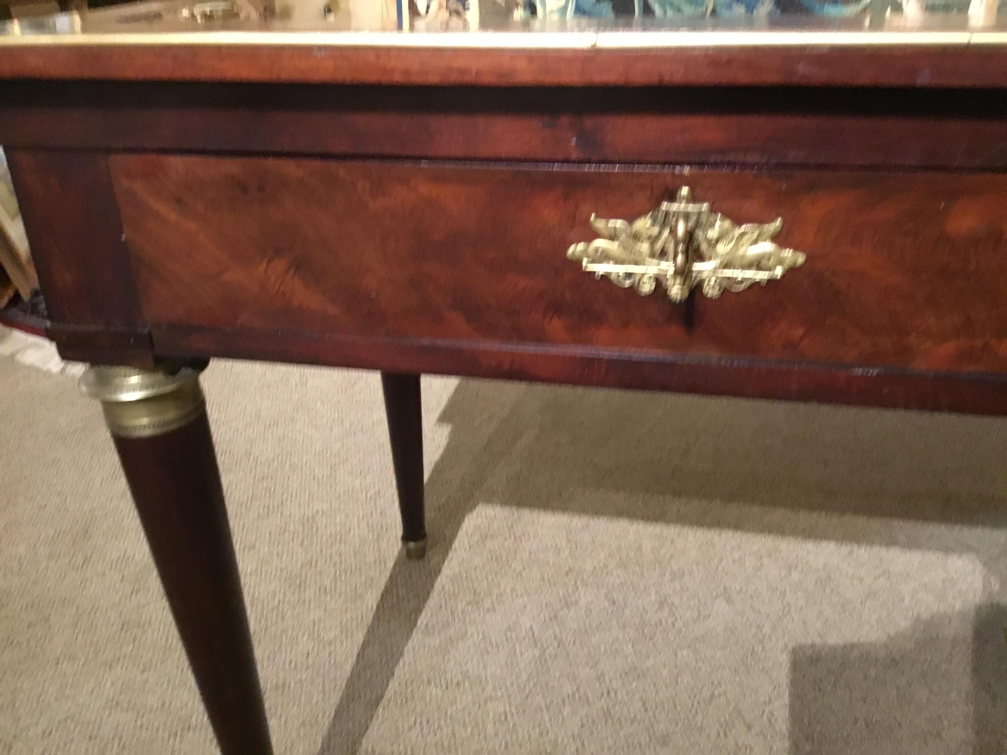 Finely crafted mahogany console or writing table on turned legs with bronze collars and toes.
Having two drawers in great working condition.