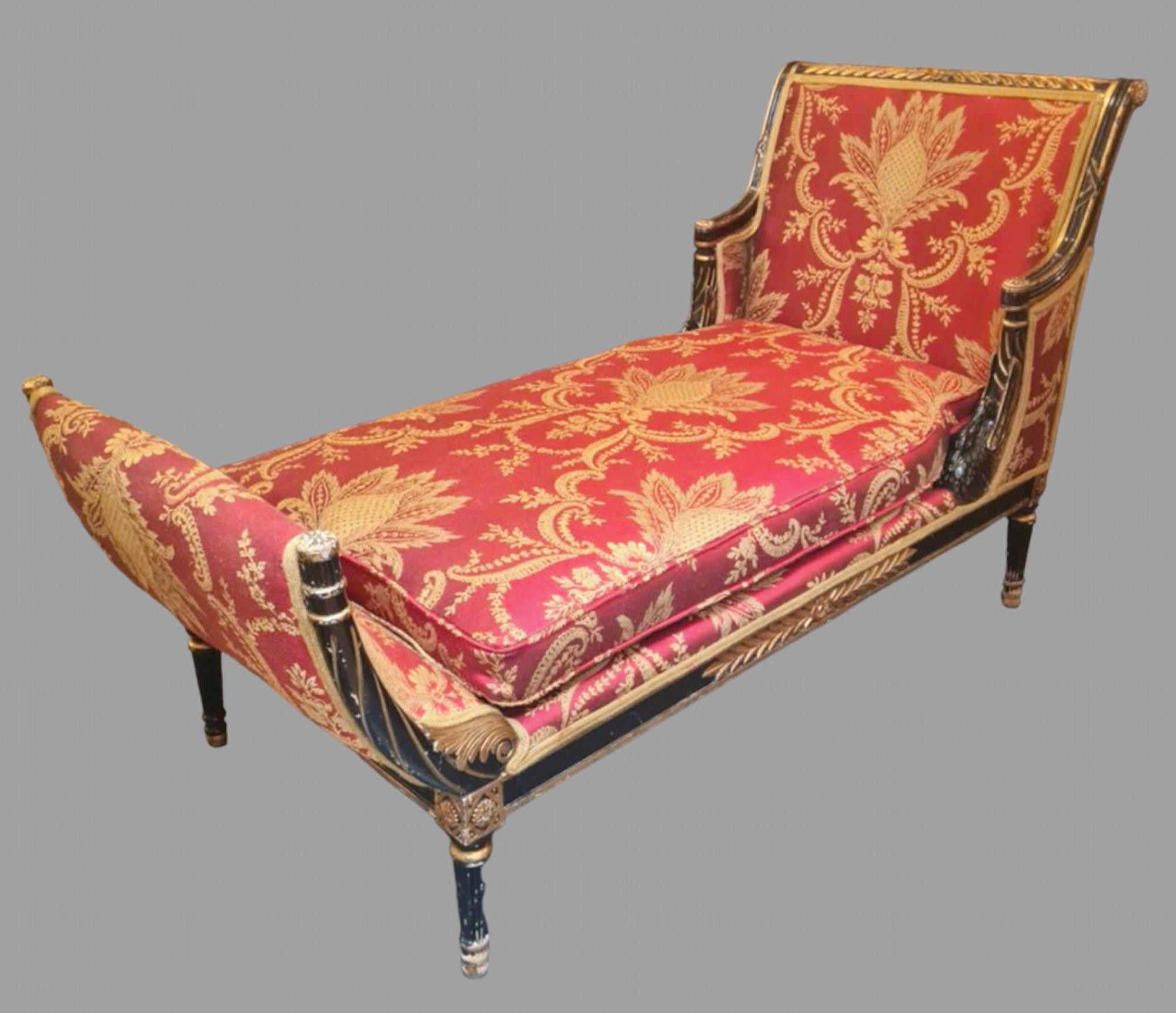 A French Empire (Second French Empire, Napoleon 111 1852-1870) Daybed decorated with gilt leaves, carved swans to arms and turned reeded legs, upholstered in red and gold patterned Bernard Thorp fabric. Seat Height 41 cm